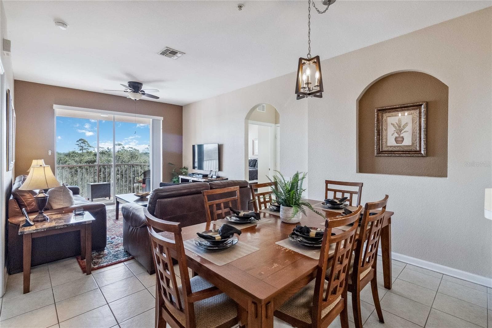 Open floor plan showing dining, living and balcony. - 2821 E ALMATON LOOP #401, KISSIMMEE
