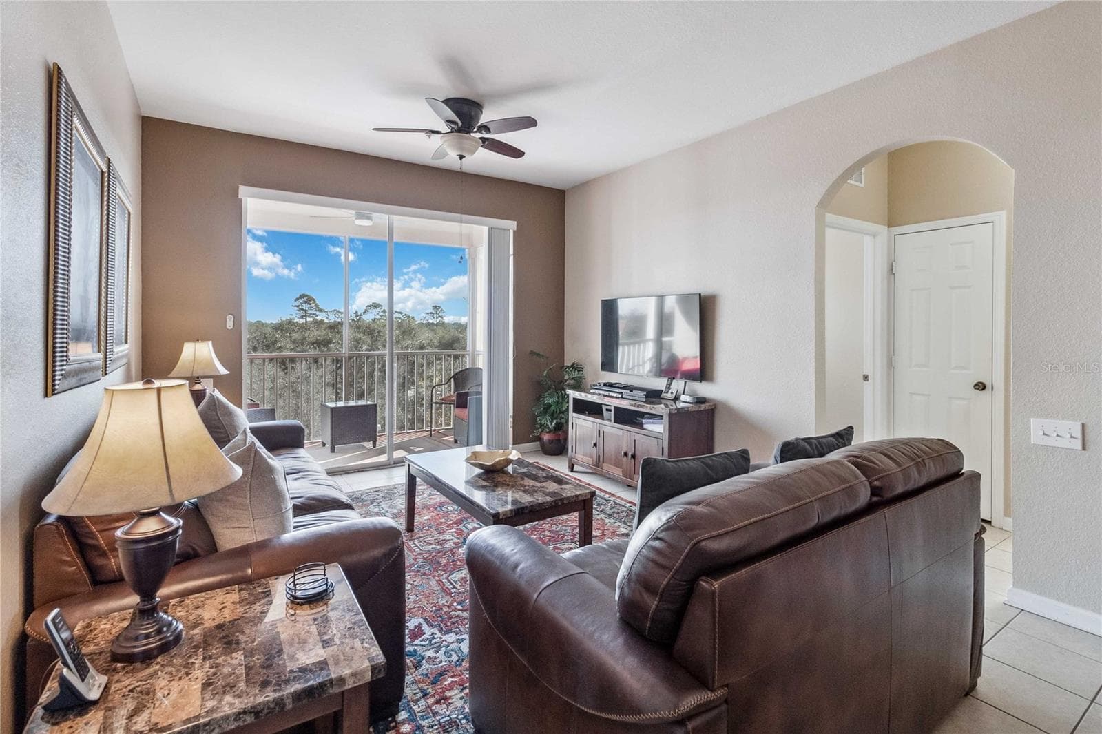 Another view of living area showing natural light. - 2821 E ALMATON LOOP #401, KISSIMMEE