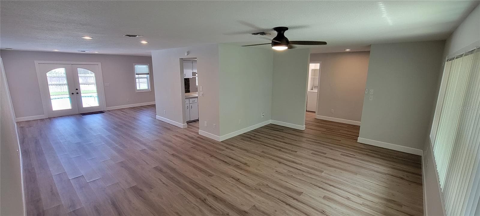 Front living room looking towards the dining area and doorway to the pool. - 7801 17TH WAY N, ST PETERSBURG