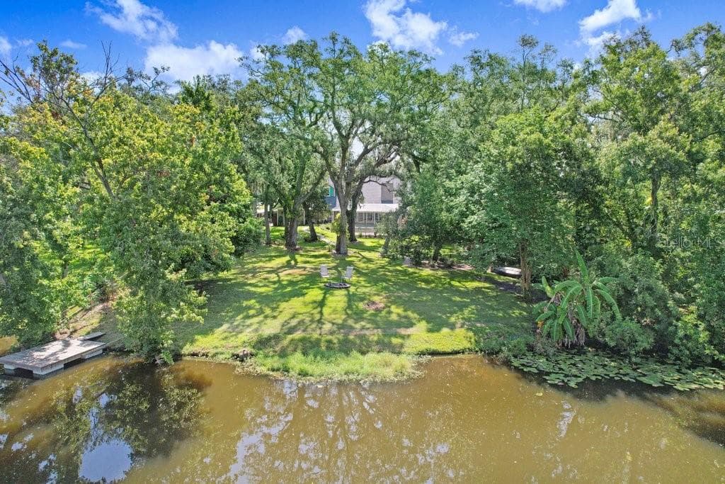 Drone view of back yard, floating dock and fire pit. - 1976 DUNLOE CIR, DUNEDIN