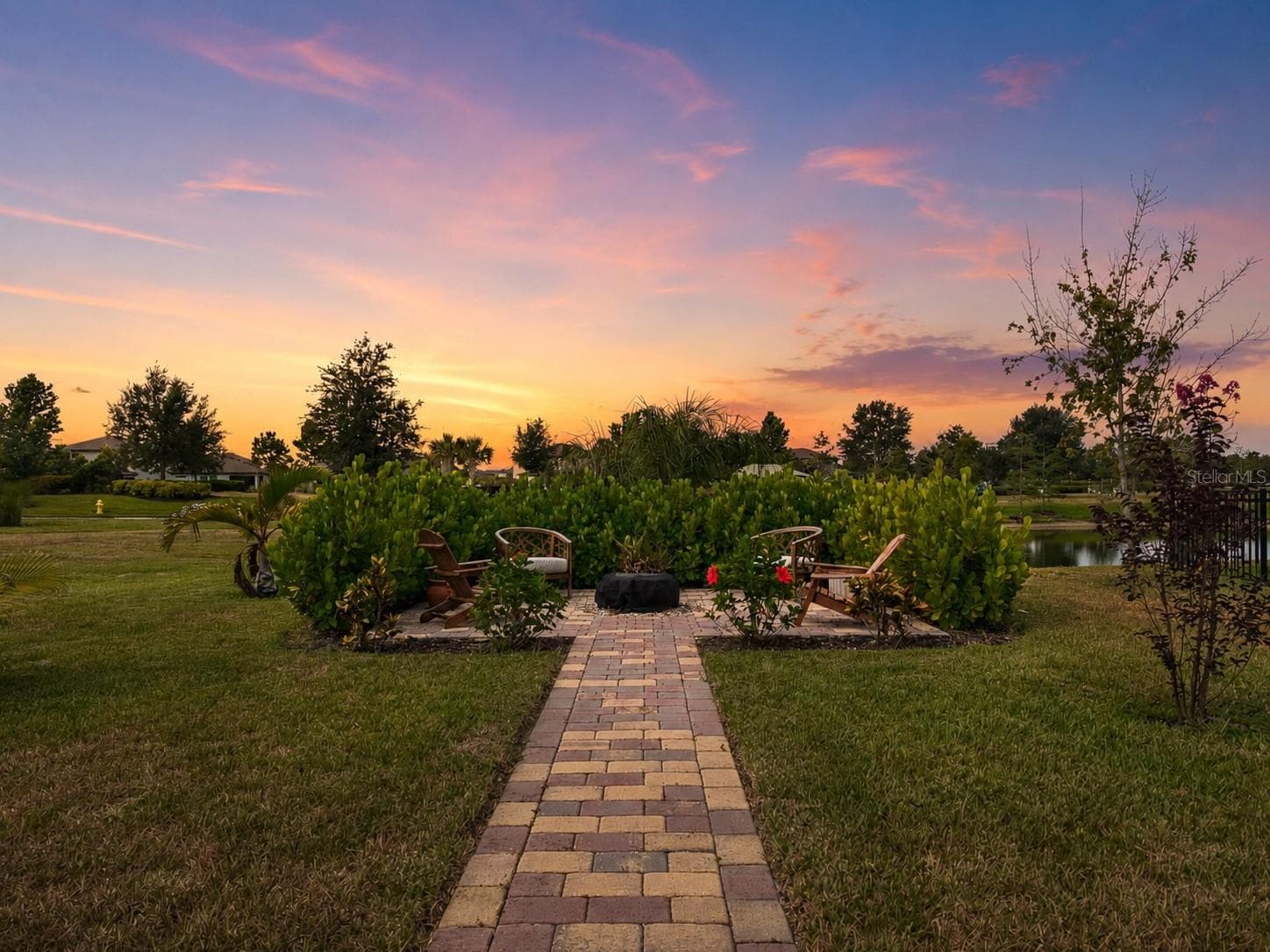 Fire pit and outdoor sitting space overlooking the pond - 11567 GALLATIN TRL, PARRISH