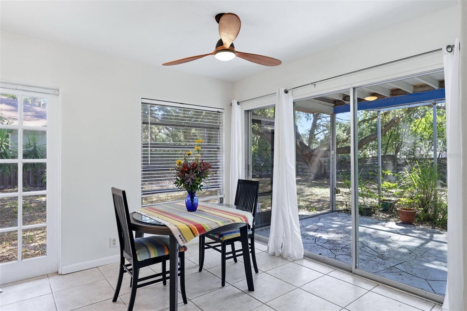 Dining room with large windows and filled with natural light - 4003 BOOTH PL, SARASOTA