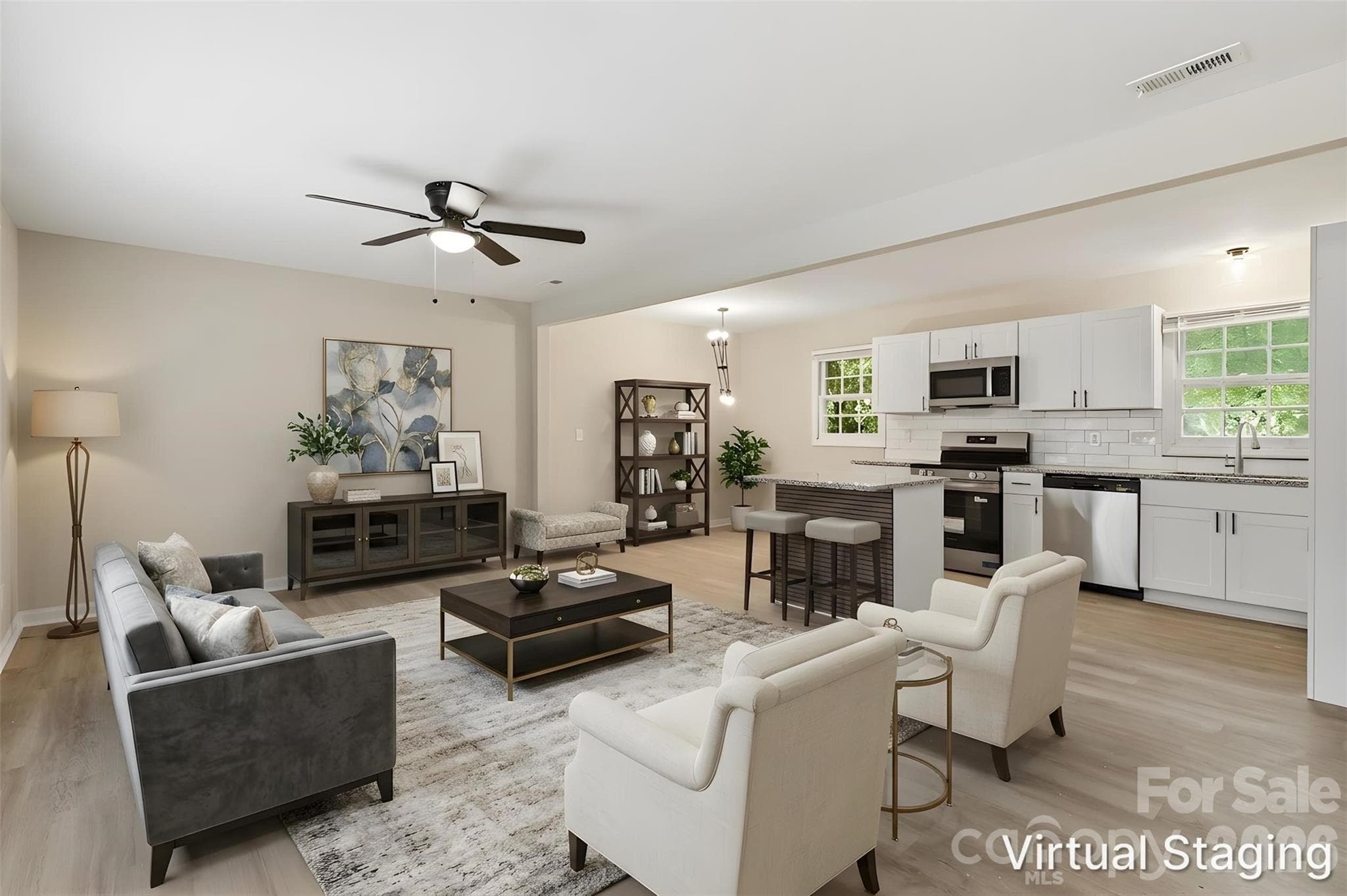 Immediately walking into the living room from the front door. An open-concept inspired layout seamlessly integrates the living room, kitchen & dining areas, providing a central space for connecting, entertaining & resetting (virtually staged & enhanced). - Charlotte
