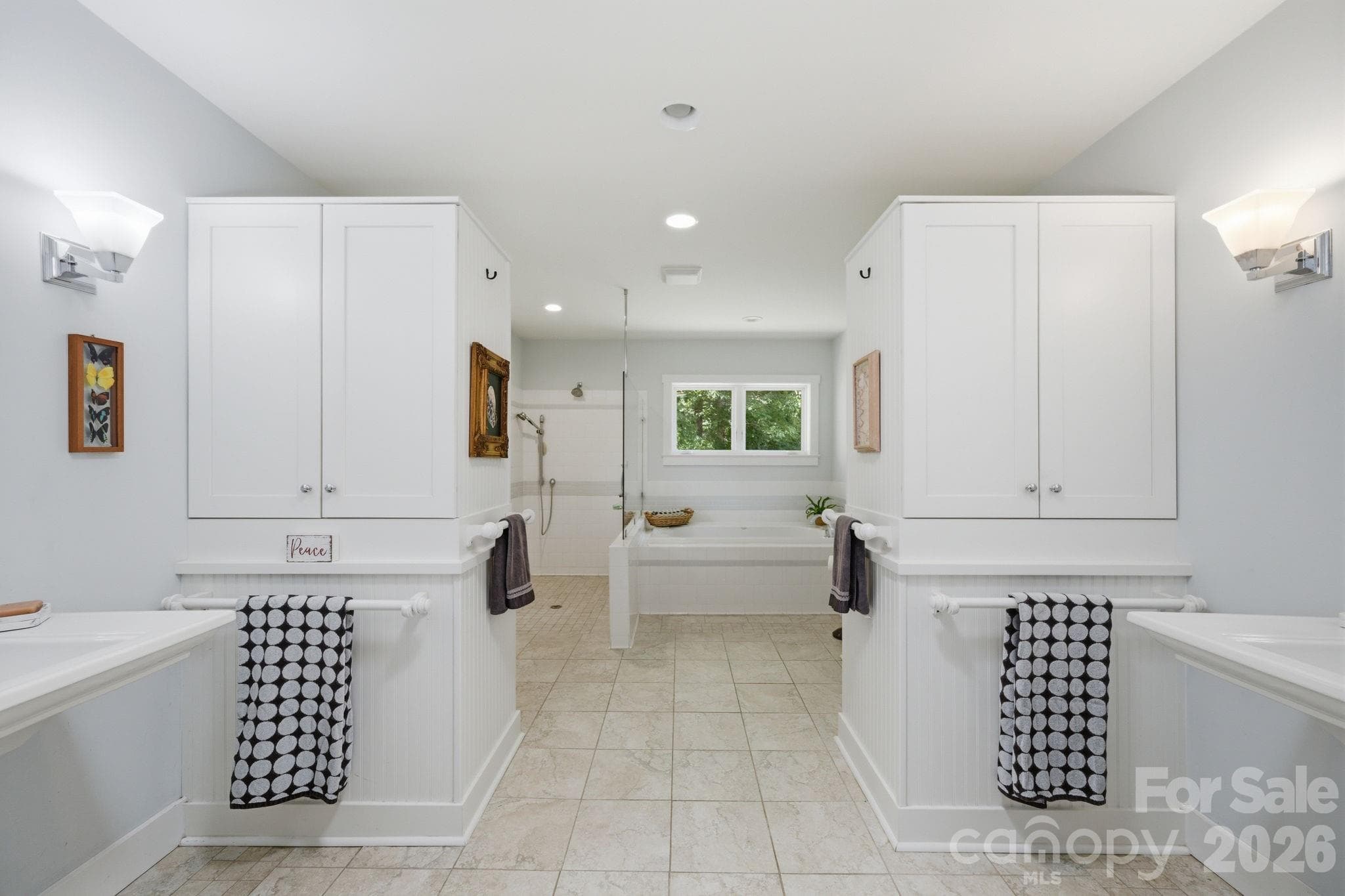 Primary bath with two pedestal sinks, built-in cabinetry, roll in tile and frameless glass shower, garden tub - Lancaster