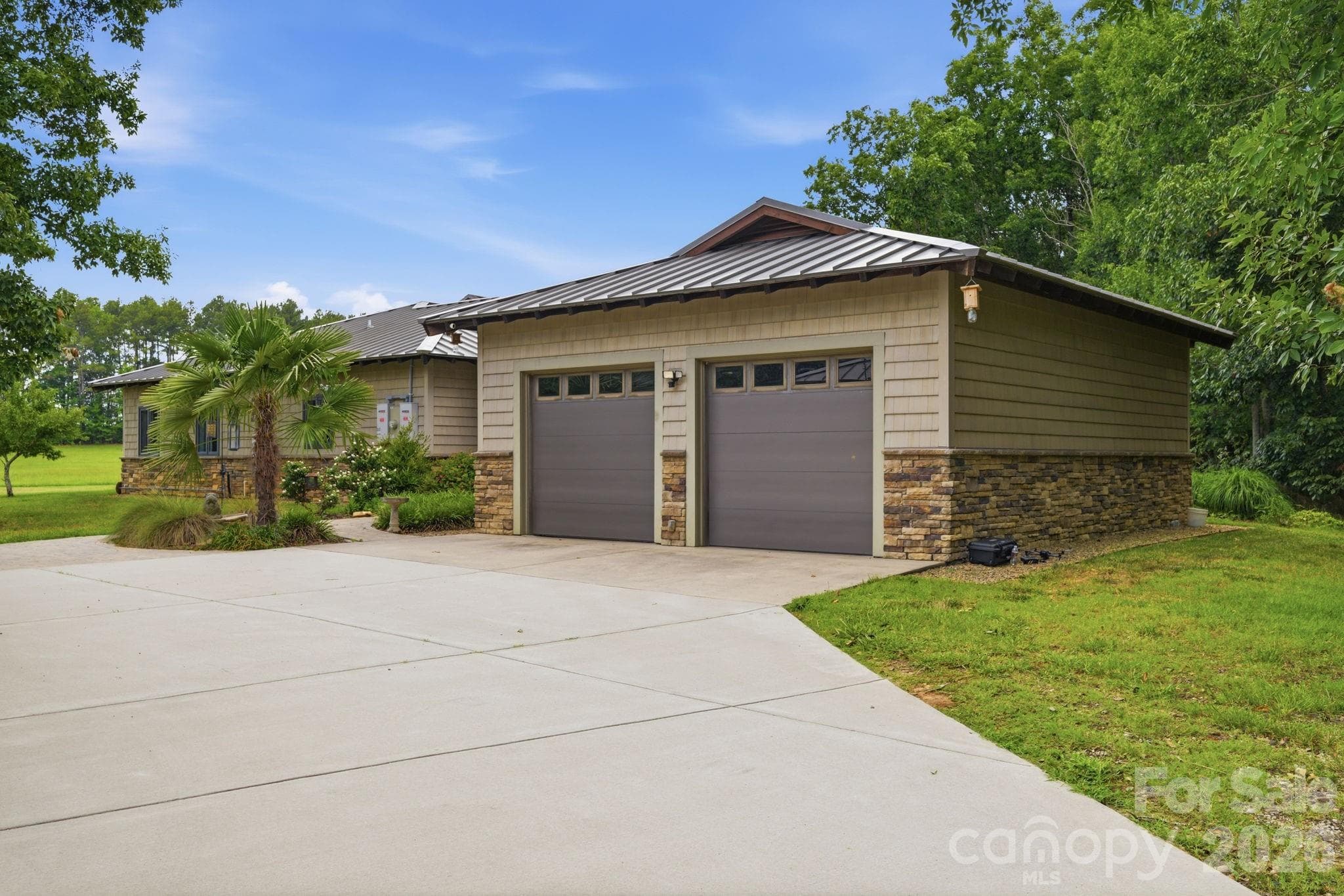 Two car side load garage, stone and Hardi-Plank siding, standing seam metal roof, Low maintenance - Lancaster