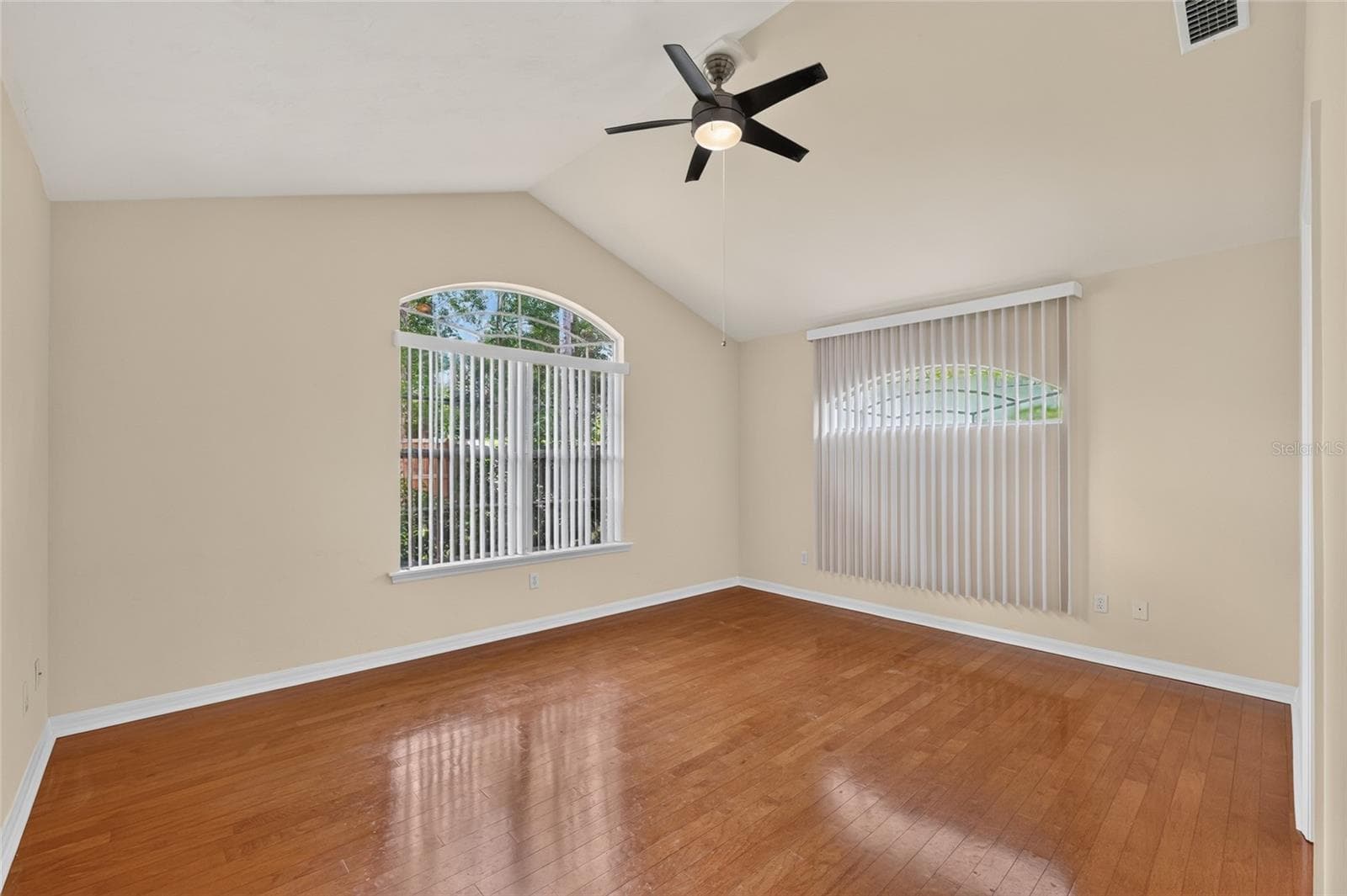 PRIMARY BEDROOM WITH WOOD FLOORS - 9437 SW 31ST LN, GAINESVILLE