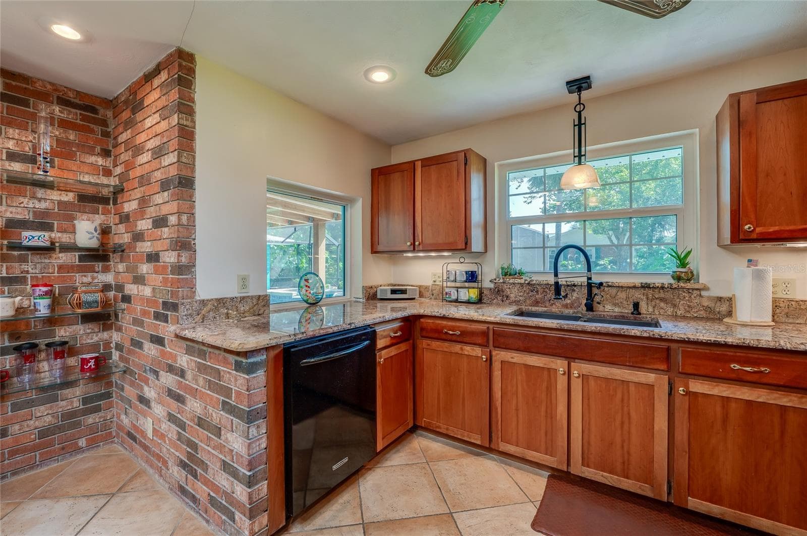 Kitchen with views to pool and backyard - 697 JOHN ANDERSON DR, ORMOND BEACH