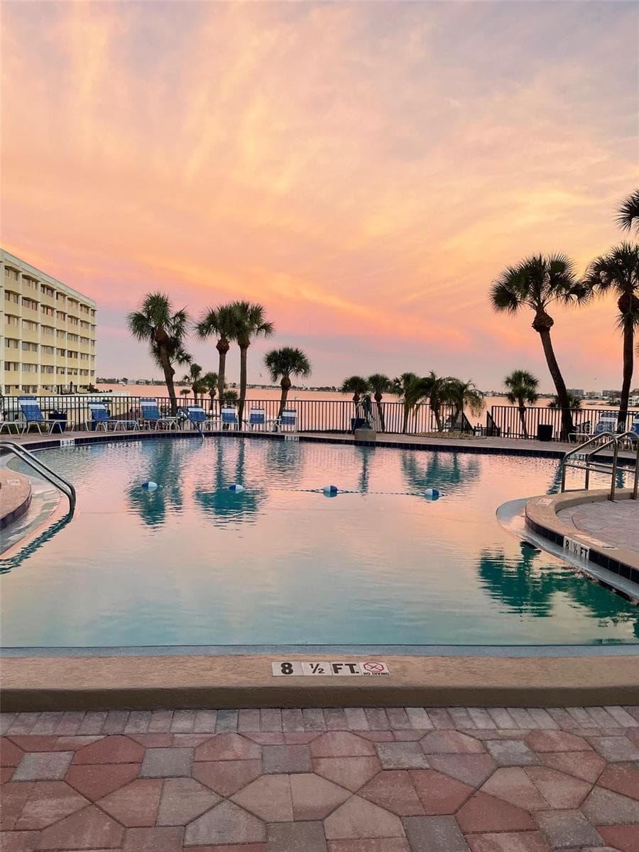 Sunrise at the pool - 100 BLUFF VIEW DR #211C, BELLEAIR BLUFFS