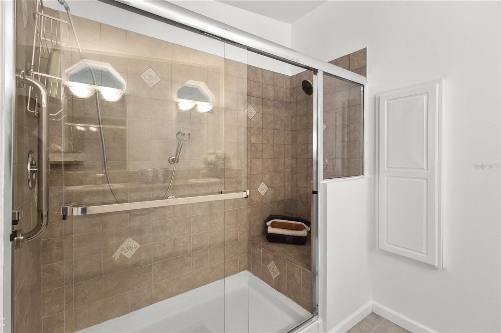 PRIMARY BATHROOM SHOWER WITH BENCH - 1710 INDIANA AVE, BRADENTON