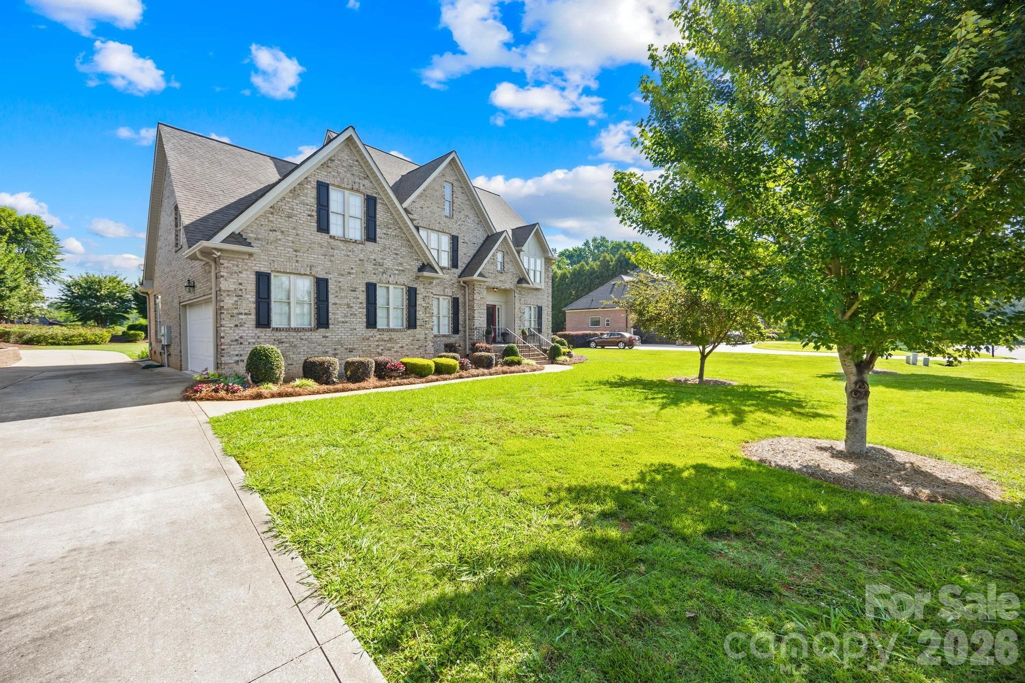 Front view of home with side load garage. Easy access in and out of property with circle drive - 105 Mandarin Drive, Mooresville