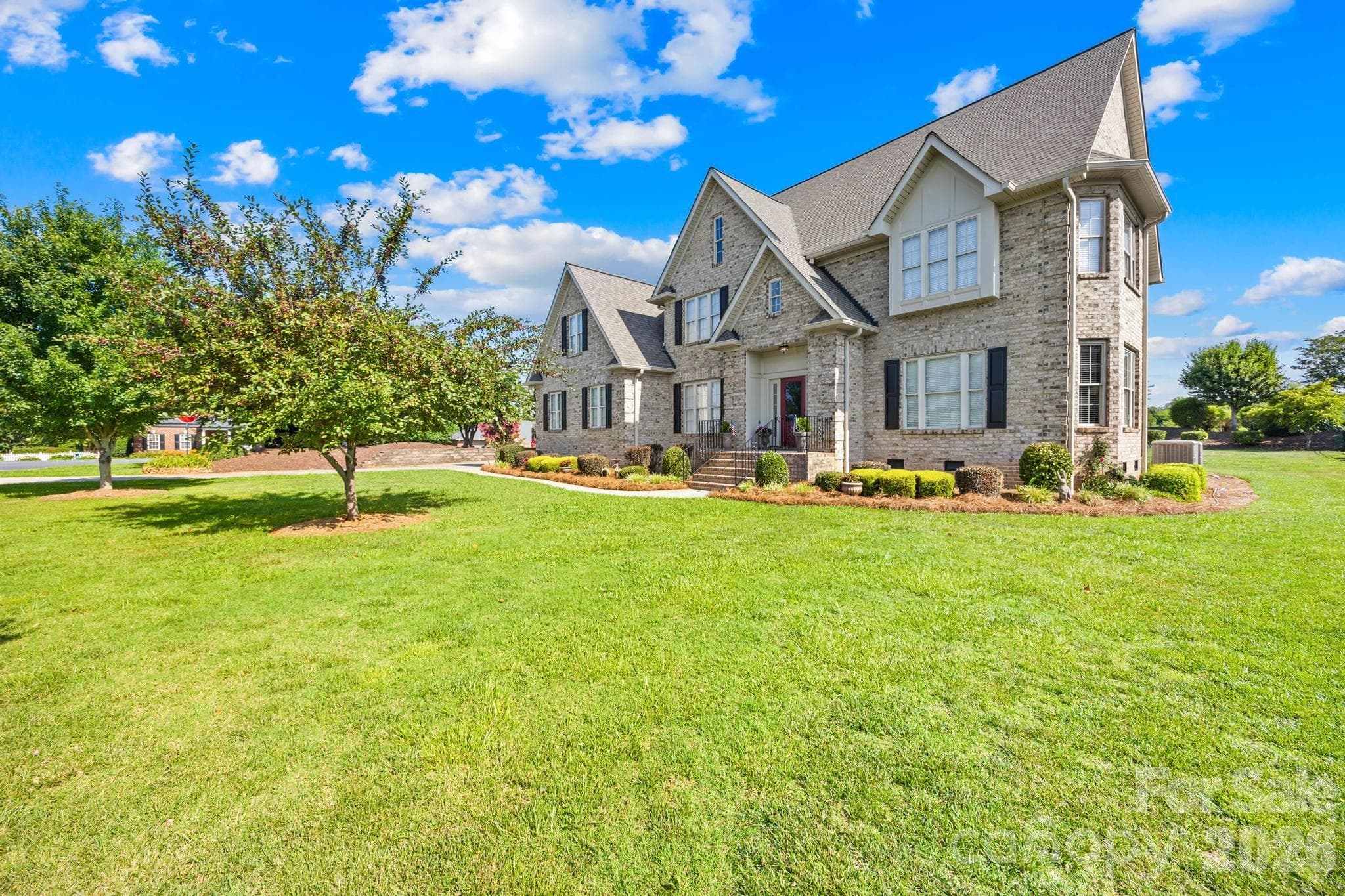 Front view of home-level lot and fruit trees. - 105 Mandarin Drive, Mooresville