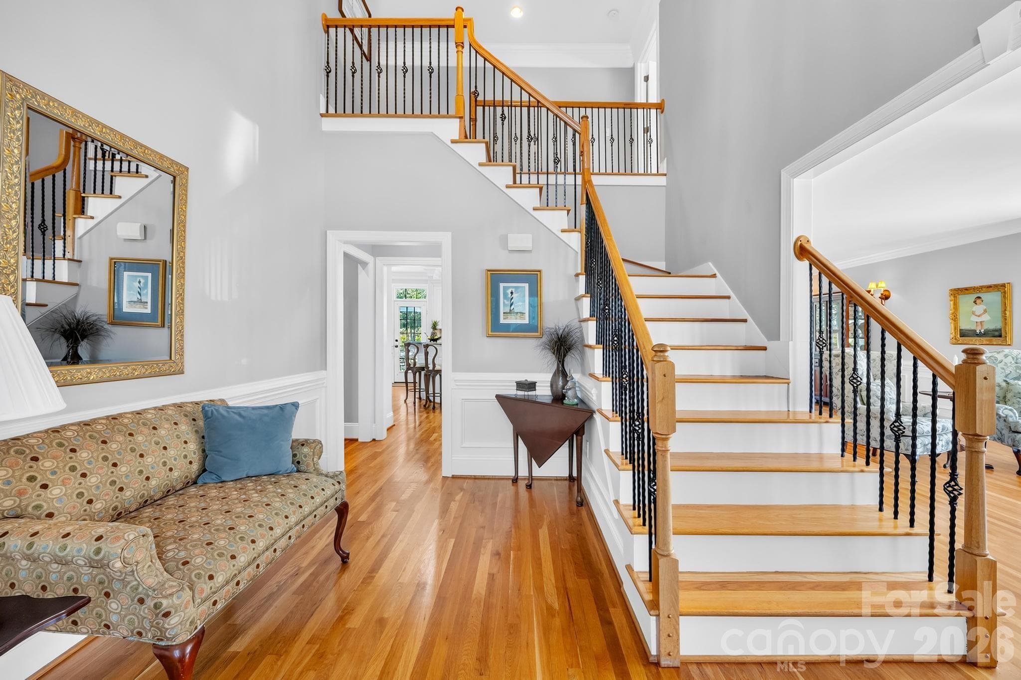 View of staircase with hardwood steps and metal spindles - 105 Mandarin Drive, Mooresville