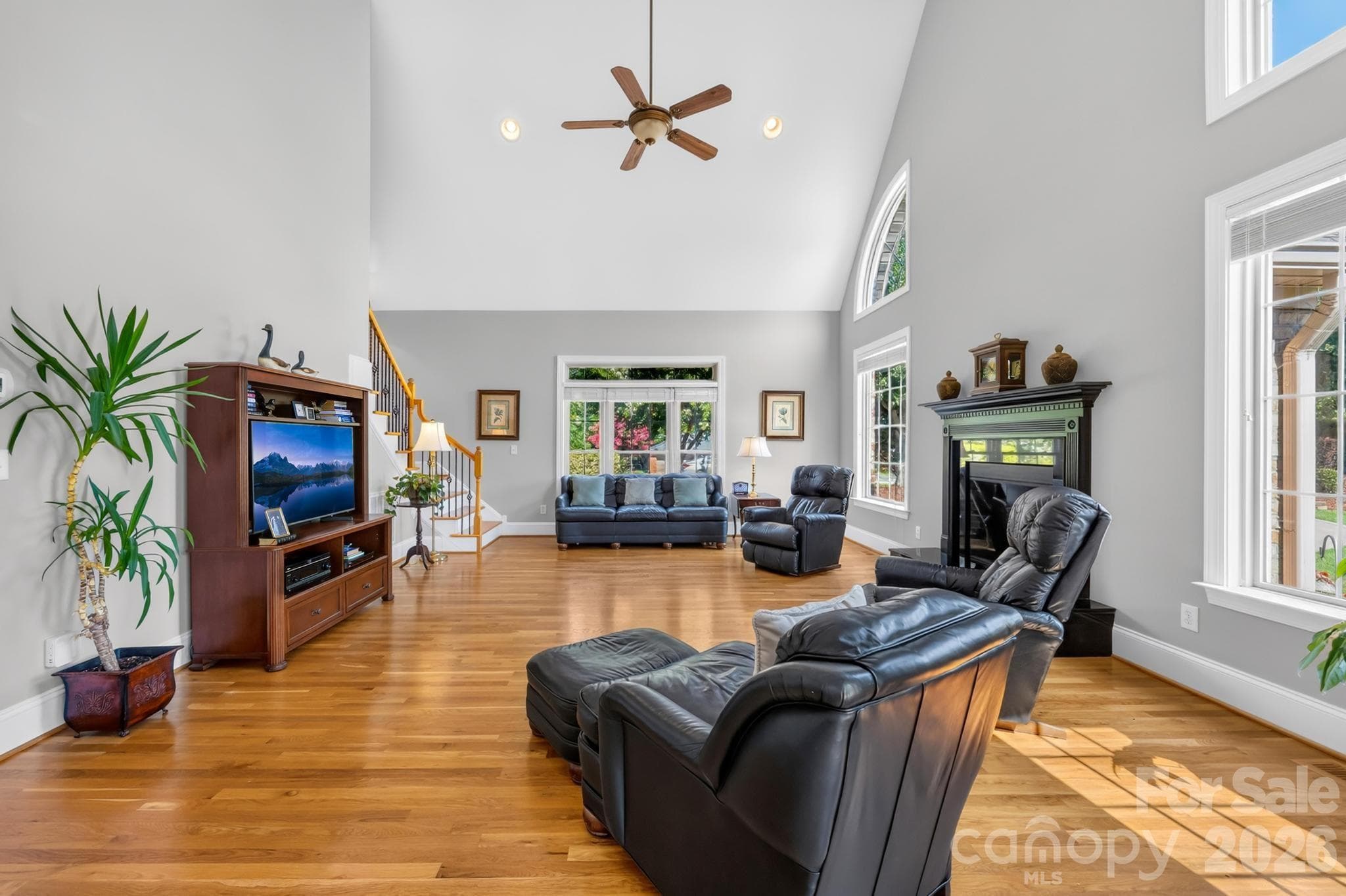 Living Room- vaulted ceilings,ceiling fan, fireplace, and upstair access from second staircase. - 105 Mandarin Drive, Mooresville