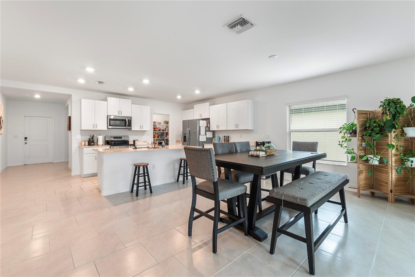 Bright dining space overlooking the backyard, perfect for everyday meals and entertaining guests. - 17177 MONTE ISOLA WAY, NORTH FORT MYERS