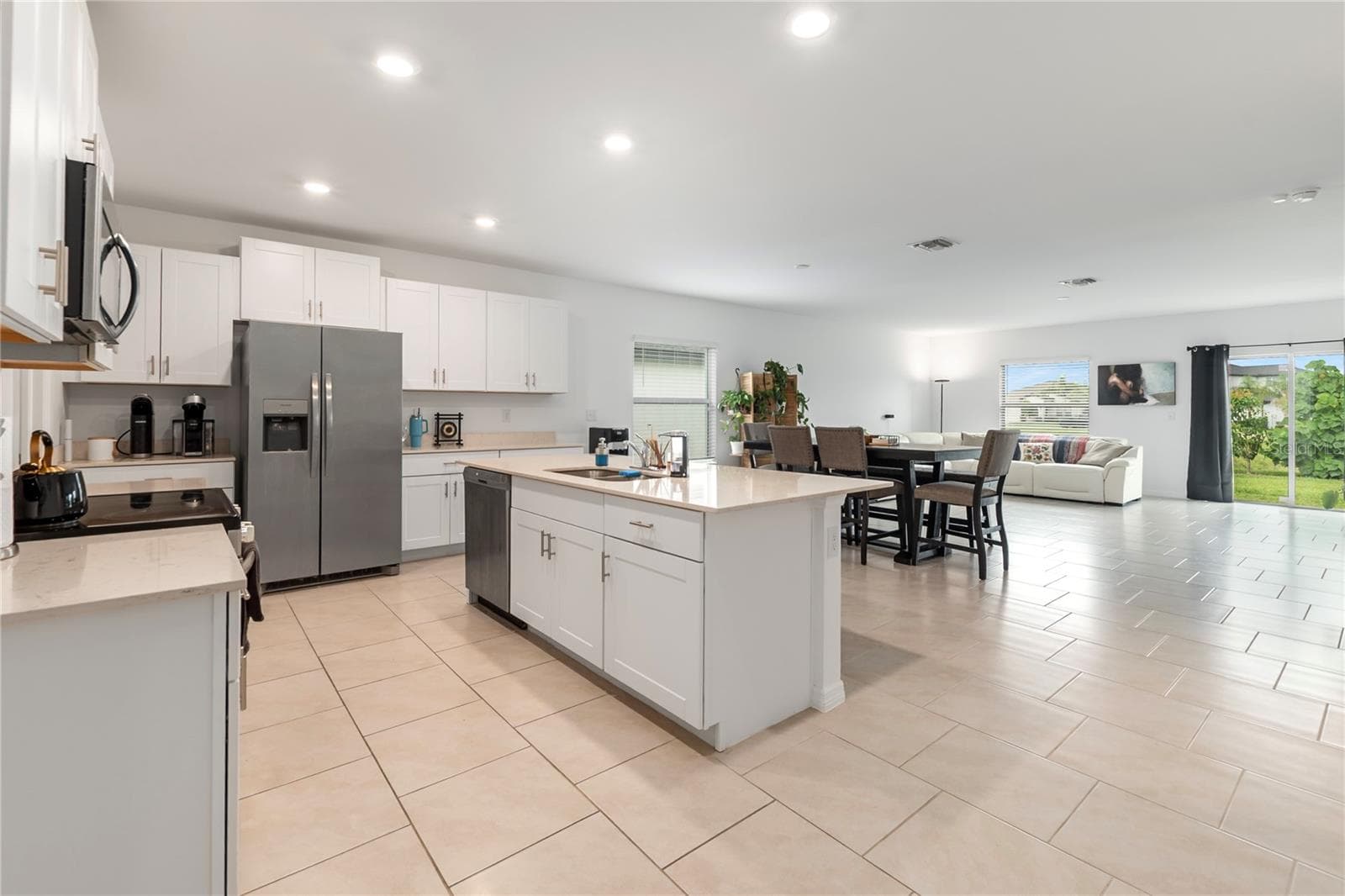Gourmet kitchen with large center island, abundant cabinetry, and seamless flow into the living and dining areas. - 17177 MONTE ISOLA WAY, NORTH FORT MYERS