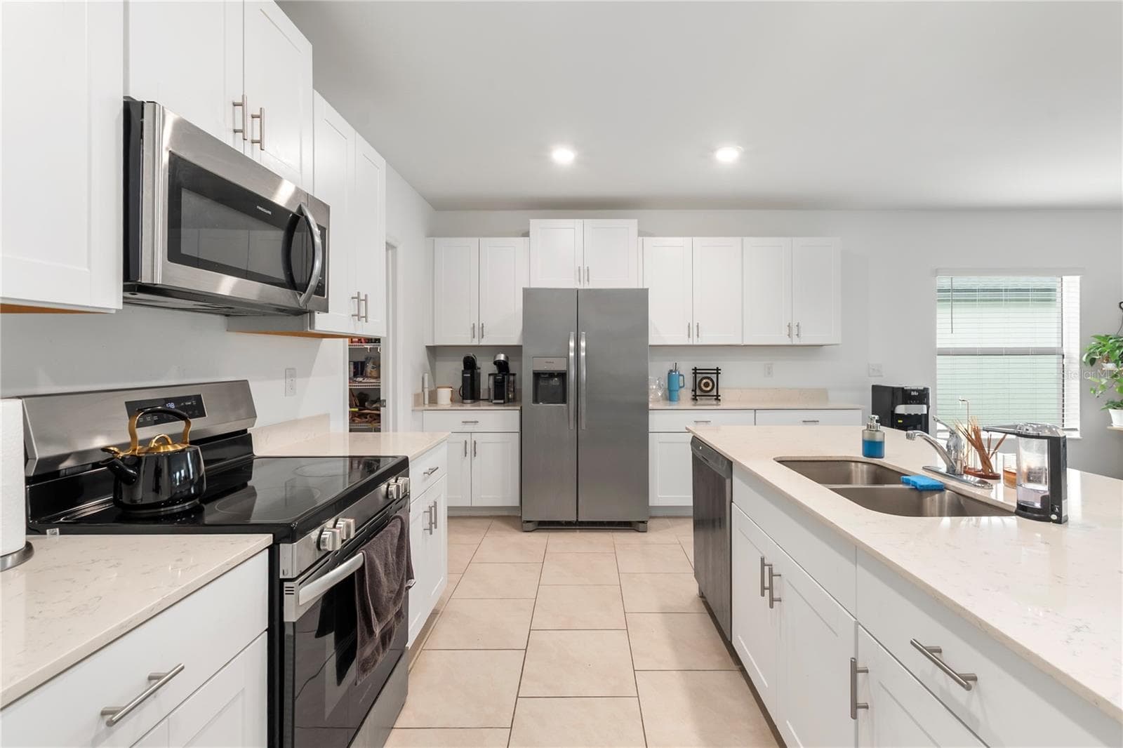 Gourmet kitchen with large center island, abundant cabinetry, and seamless flow into the living and dining areas. - 17177 MONTE ISOLA WAY, NORTH FORT MYERS