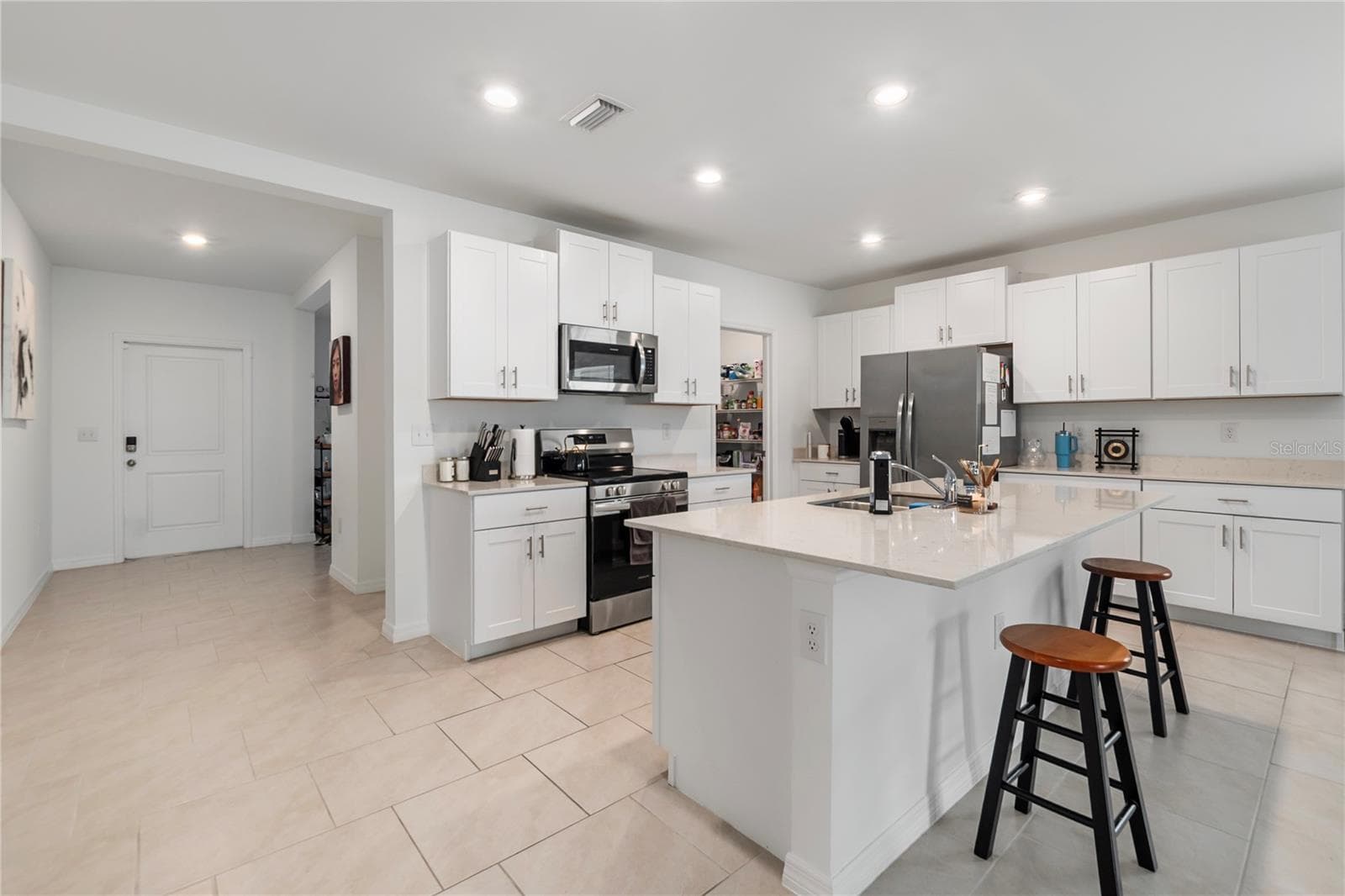 Gourmet kitchen with large center island, abundant cabinetry, and seamless flow into the living and dining areas. - 17177 MONTE ISOLA WAY, NORTH FORT MYERS