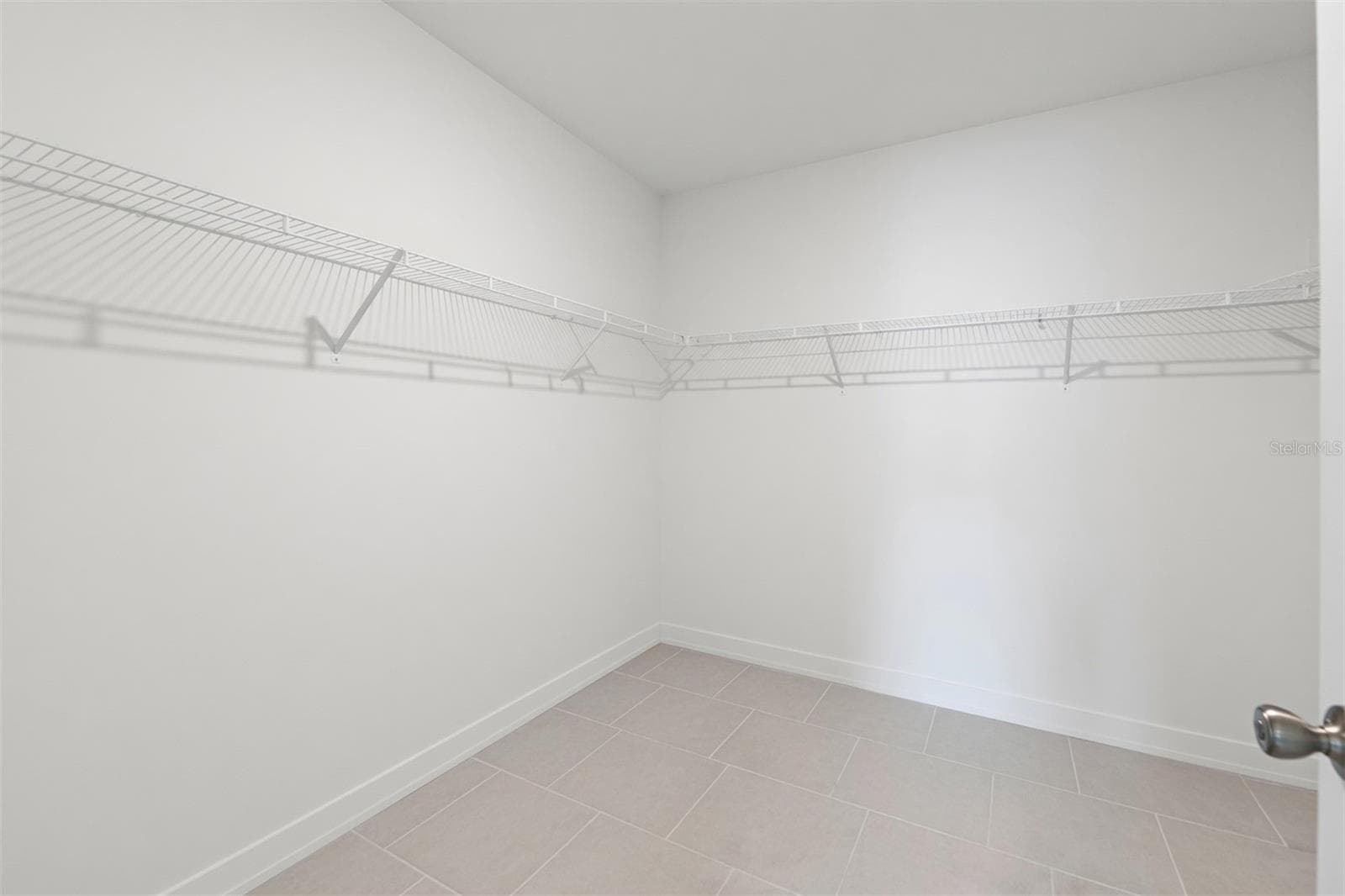 Oversized walk-in closet offering exceptional storage and organization in the primary suite. - 17177 MONTE ISOLA WAY, NORTH FORT MYERS