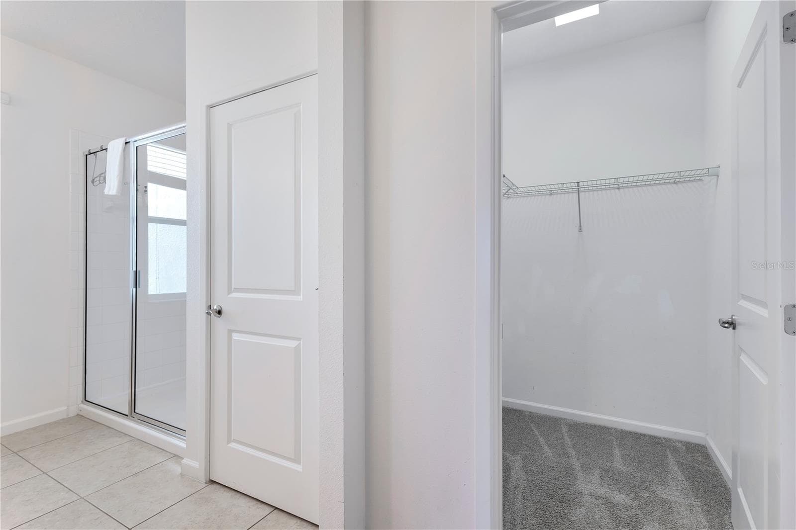 First floor primary ensuite with walk-in closet. - 210 BALLO DR, KISSIMMEE