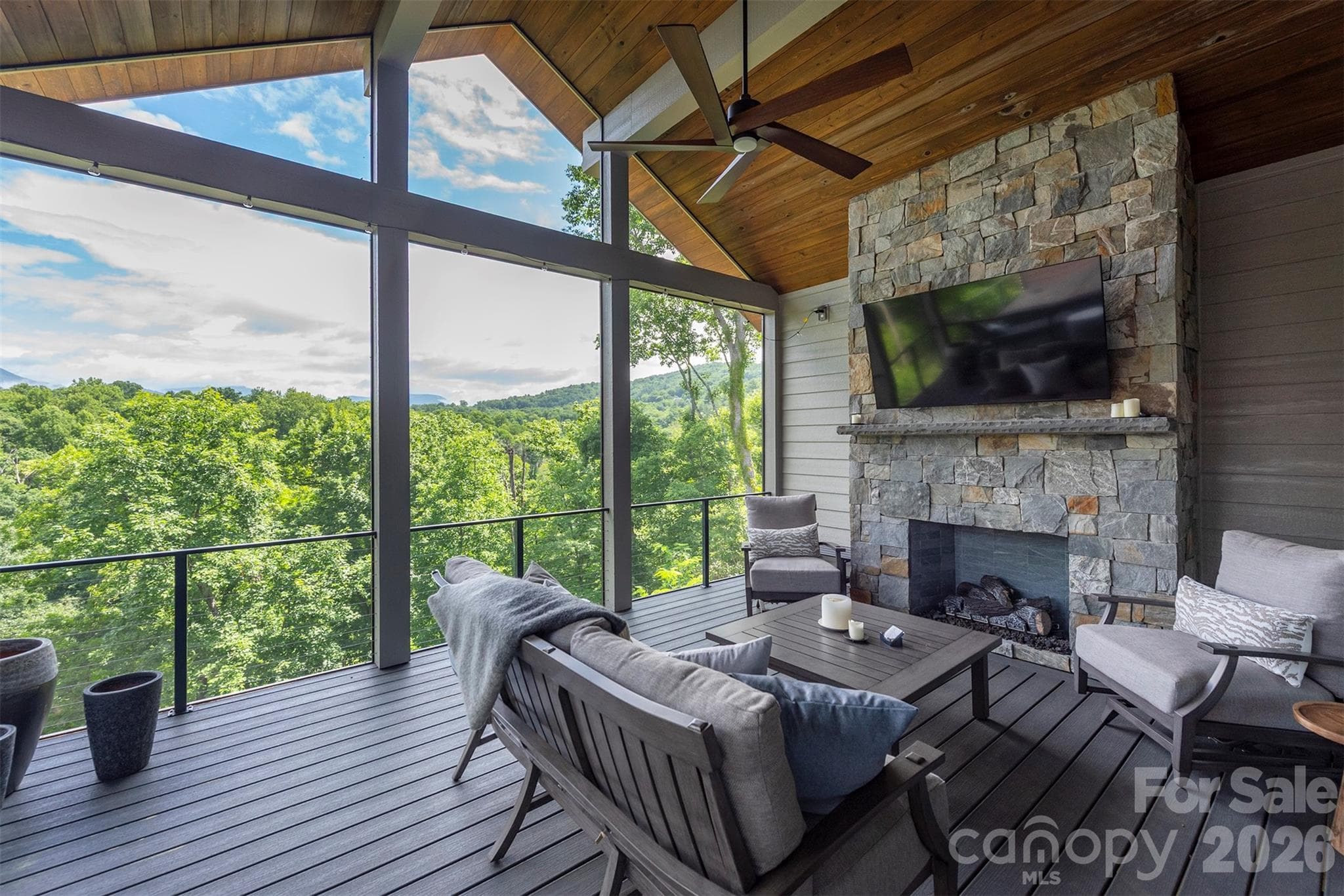 Enjoy the main level covered porch with gas fireplace and mountain views - Asheville