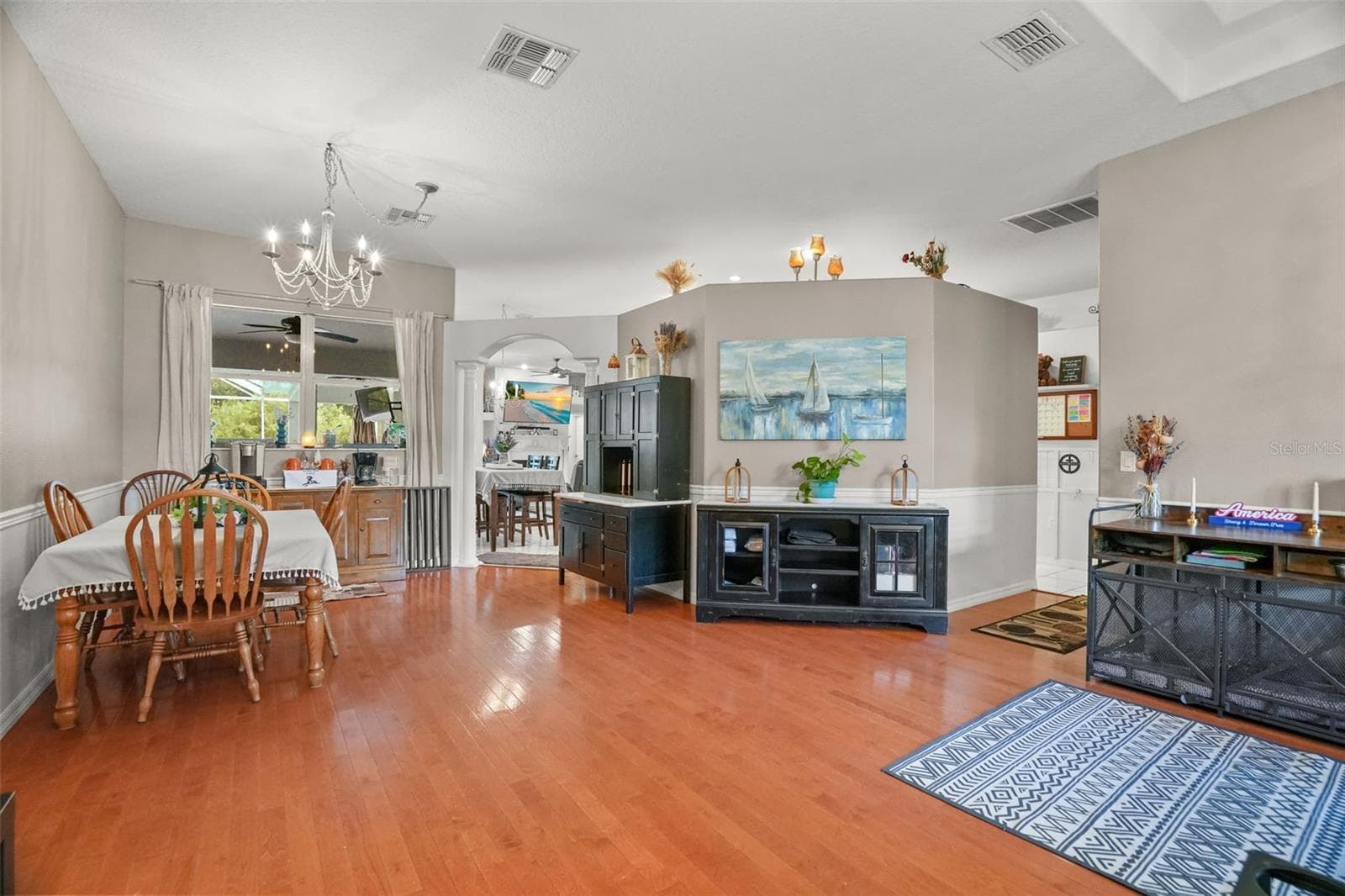 As you enter the home, formal living and dining room with wood flooring - 2117 LARKSPUR CT, TRINITY