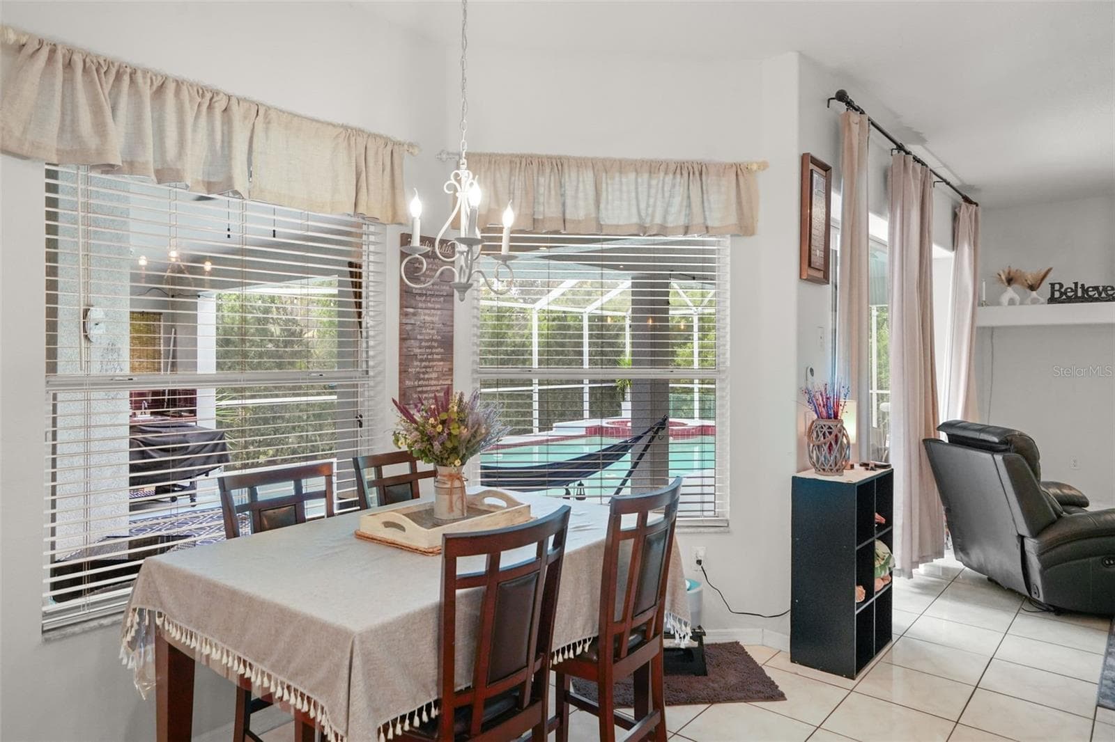 Dining area with sweeping views of the pool! - 2117 LARKSPUR CT, TRINITY