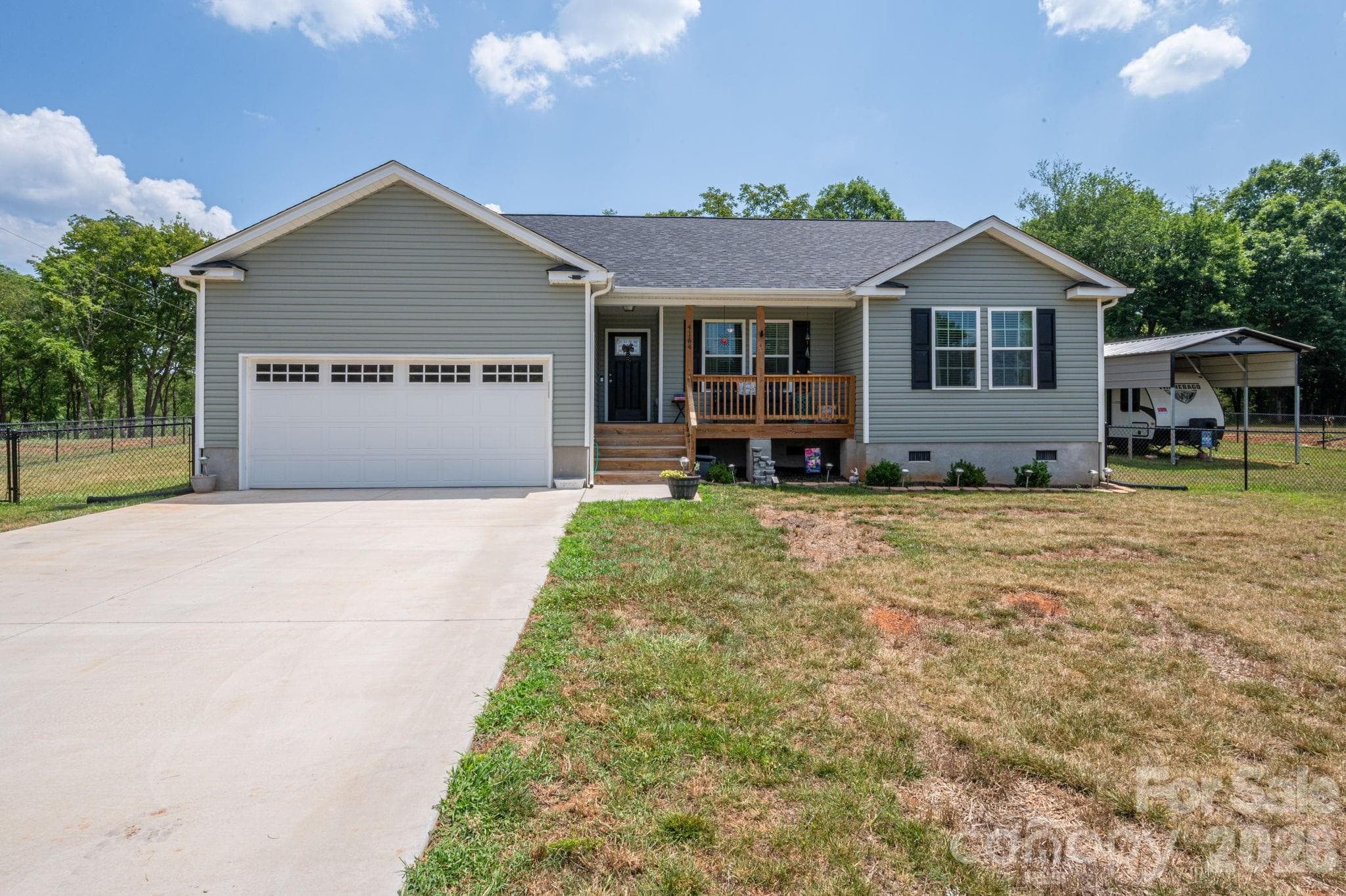 Large front yard and wide concrete driveway - Newton