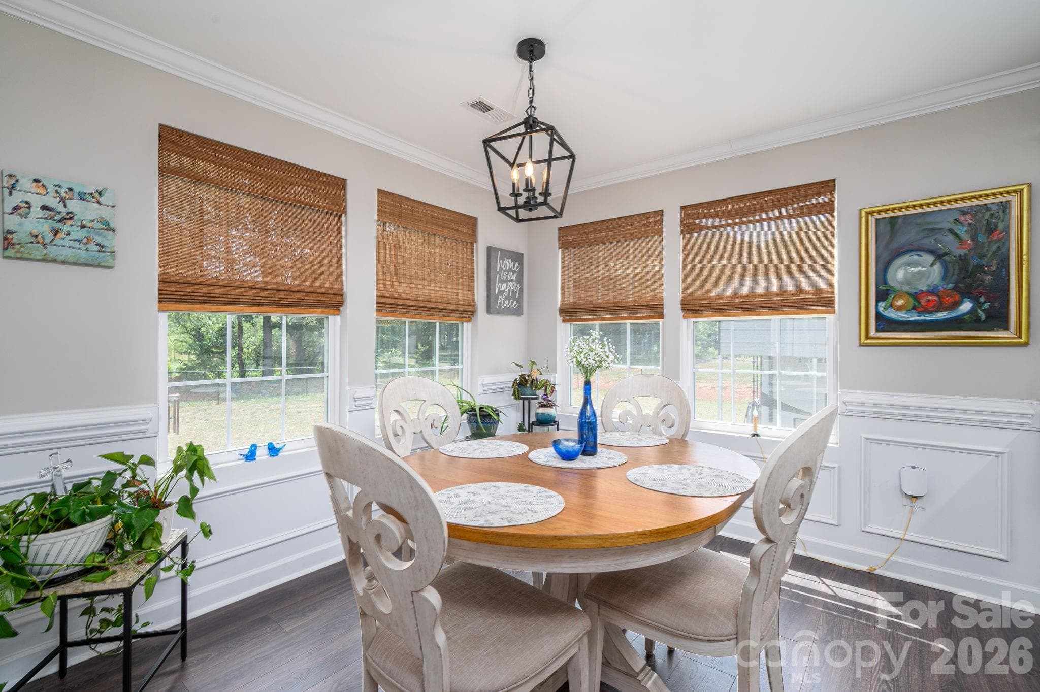 Dining area with a wonderful view of outdoors through the numerous windows. Added decorative wainscot - Newton