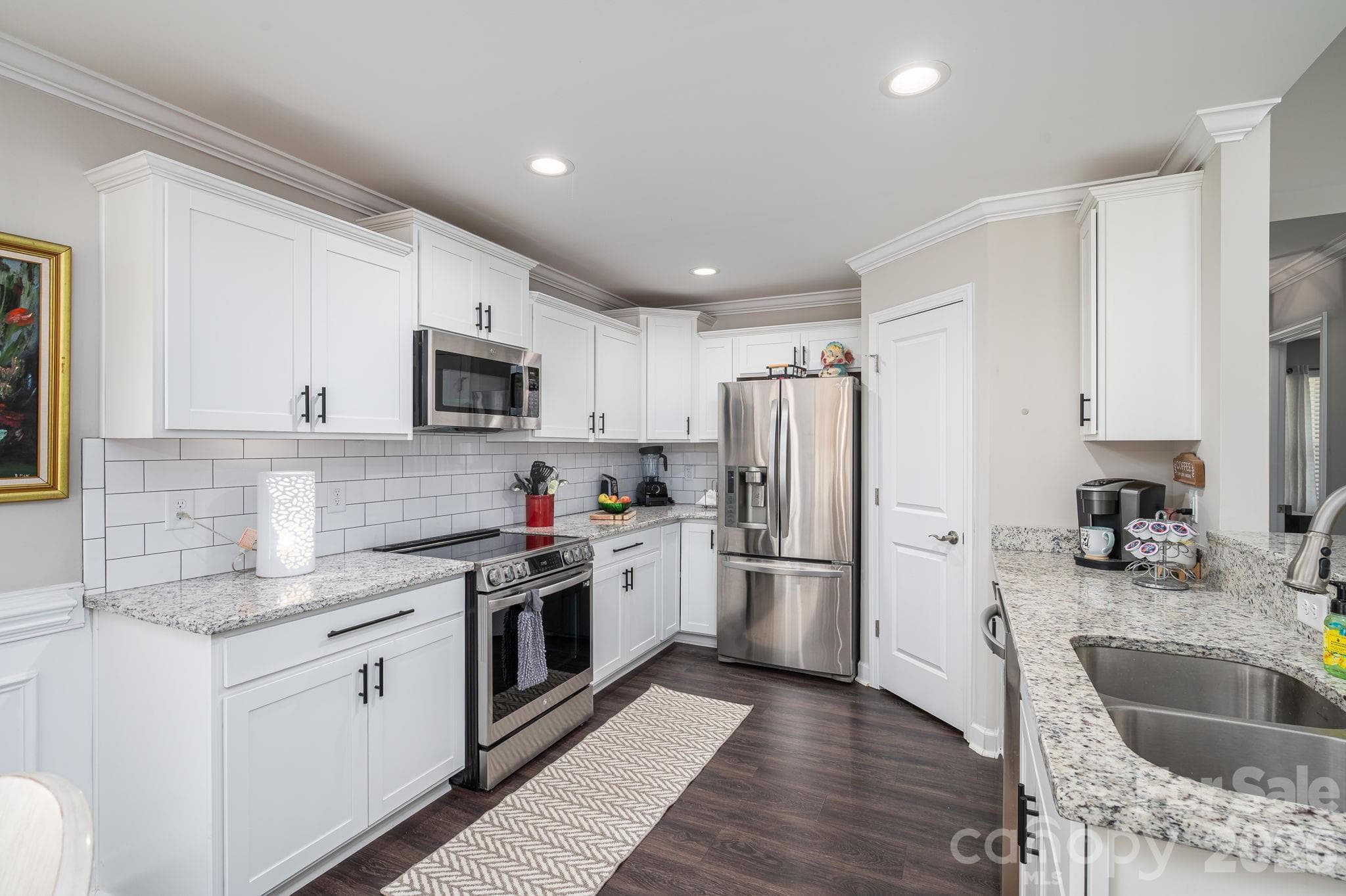 Beautiful white kitchen with stainless steel appliances - Newton