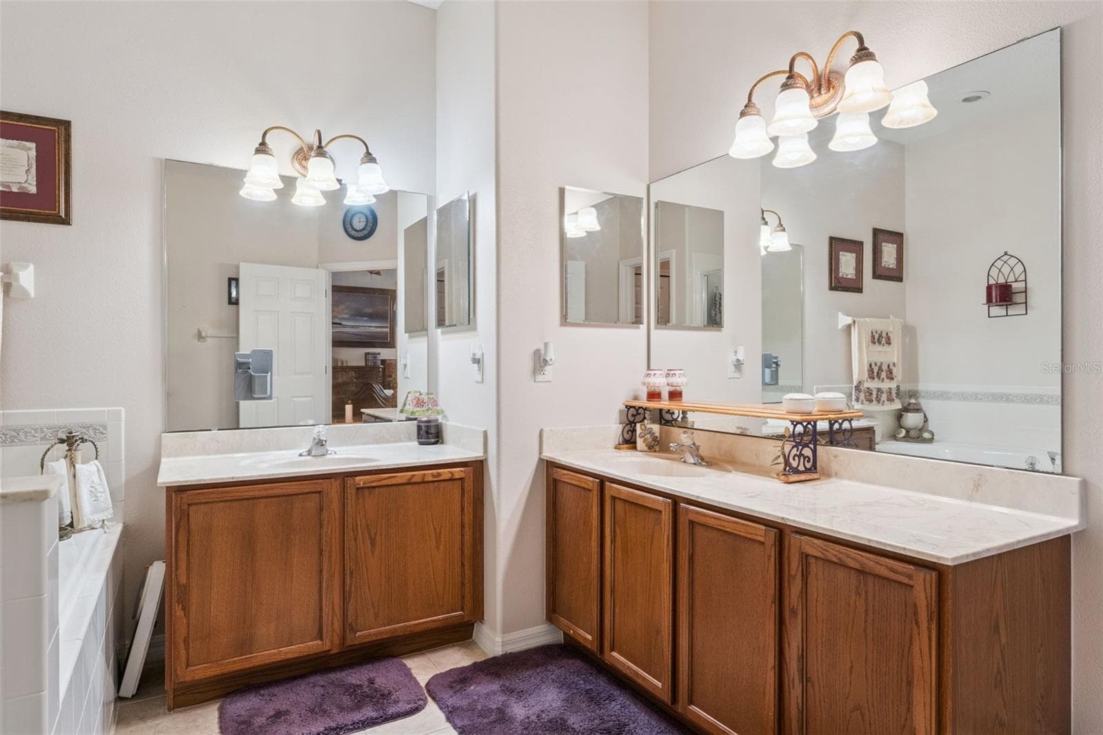 primary bathroom features dual vanities - 9955 MEDALLION BLUFF LN, ORLANDO