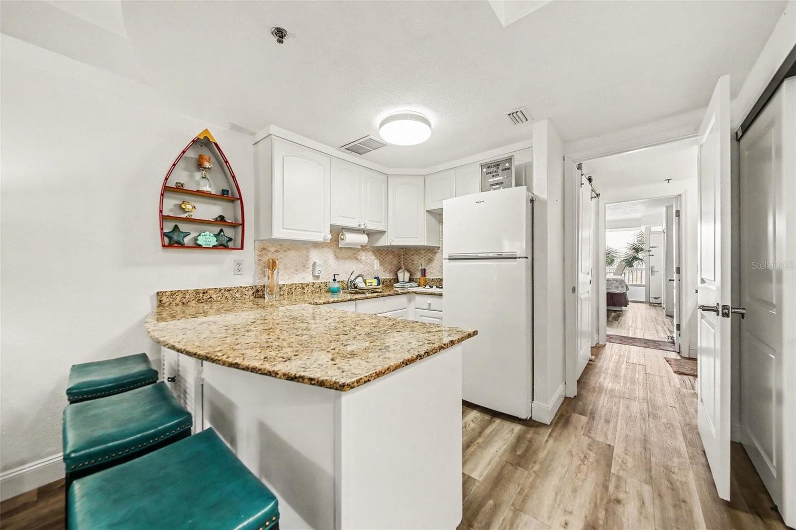 kitchen with bar stools - 2700 N ATLANTIC AVE #214, DAYTONA BEACH