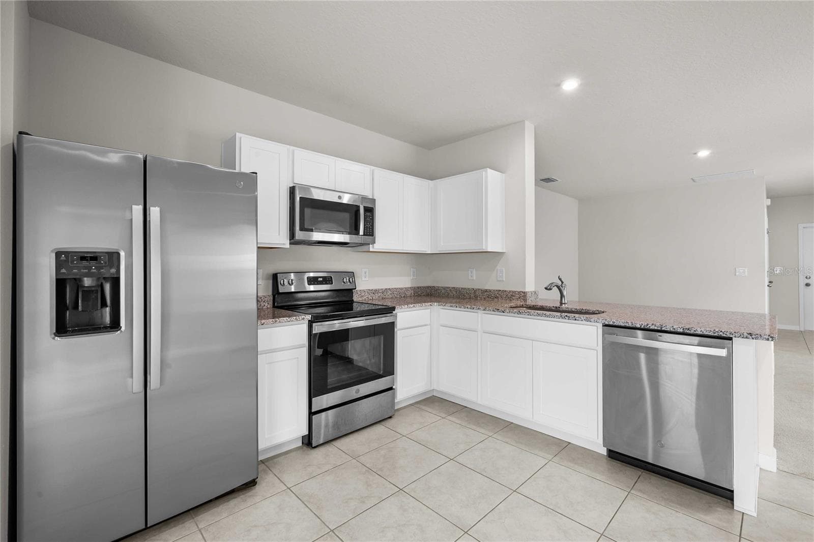 The kitchen has SS appliances - 35155 JOMAR AVE, ZEPHYRHILLS