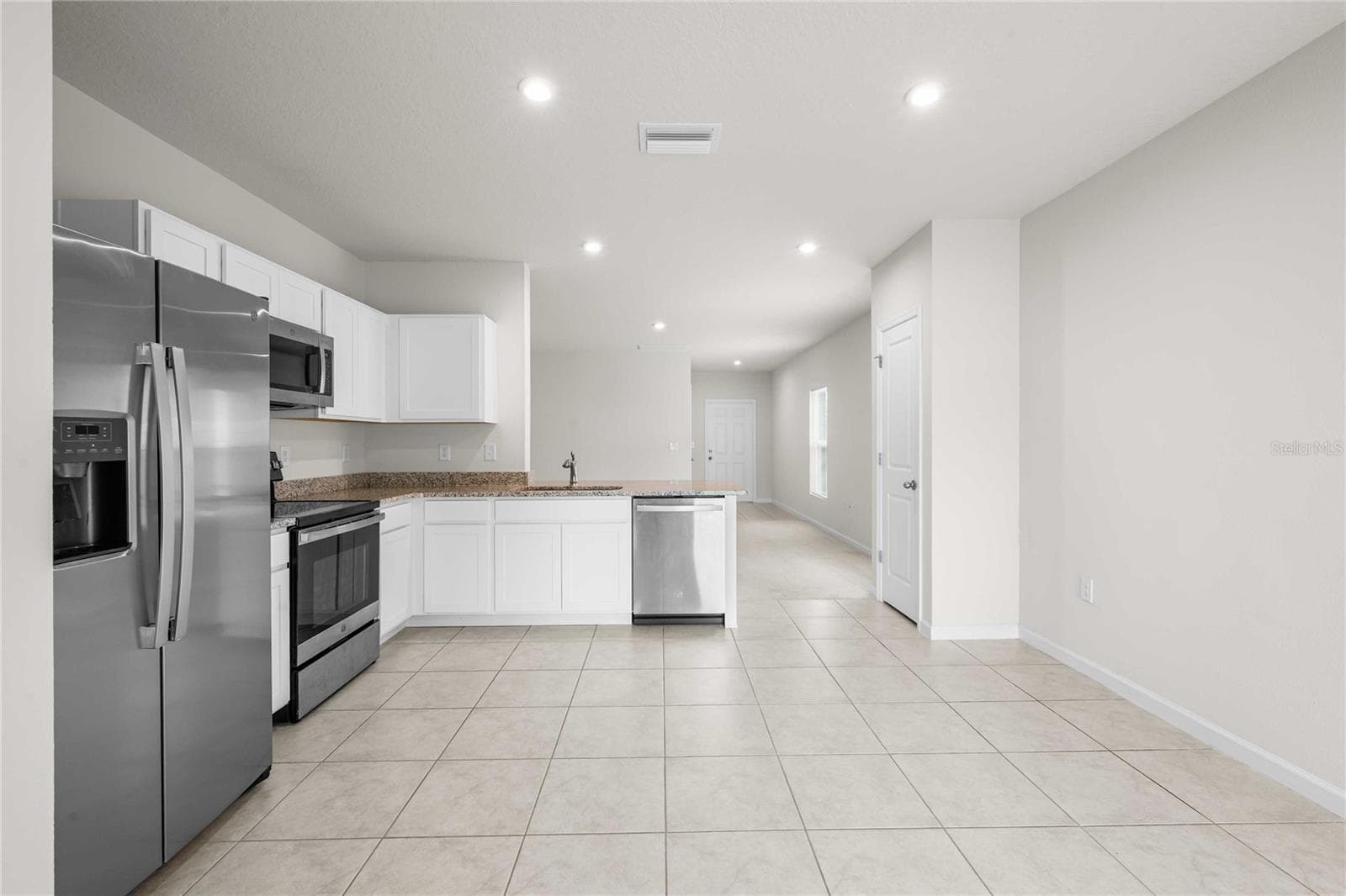 The kitchen can accommodate a large table or an island if you prefer - 35155 JOMAR AVE, ZEPHYRHILLS