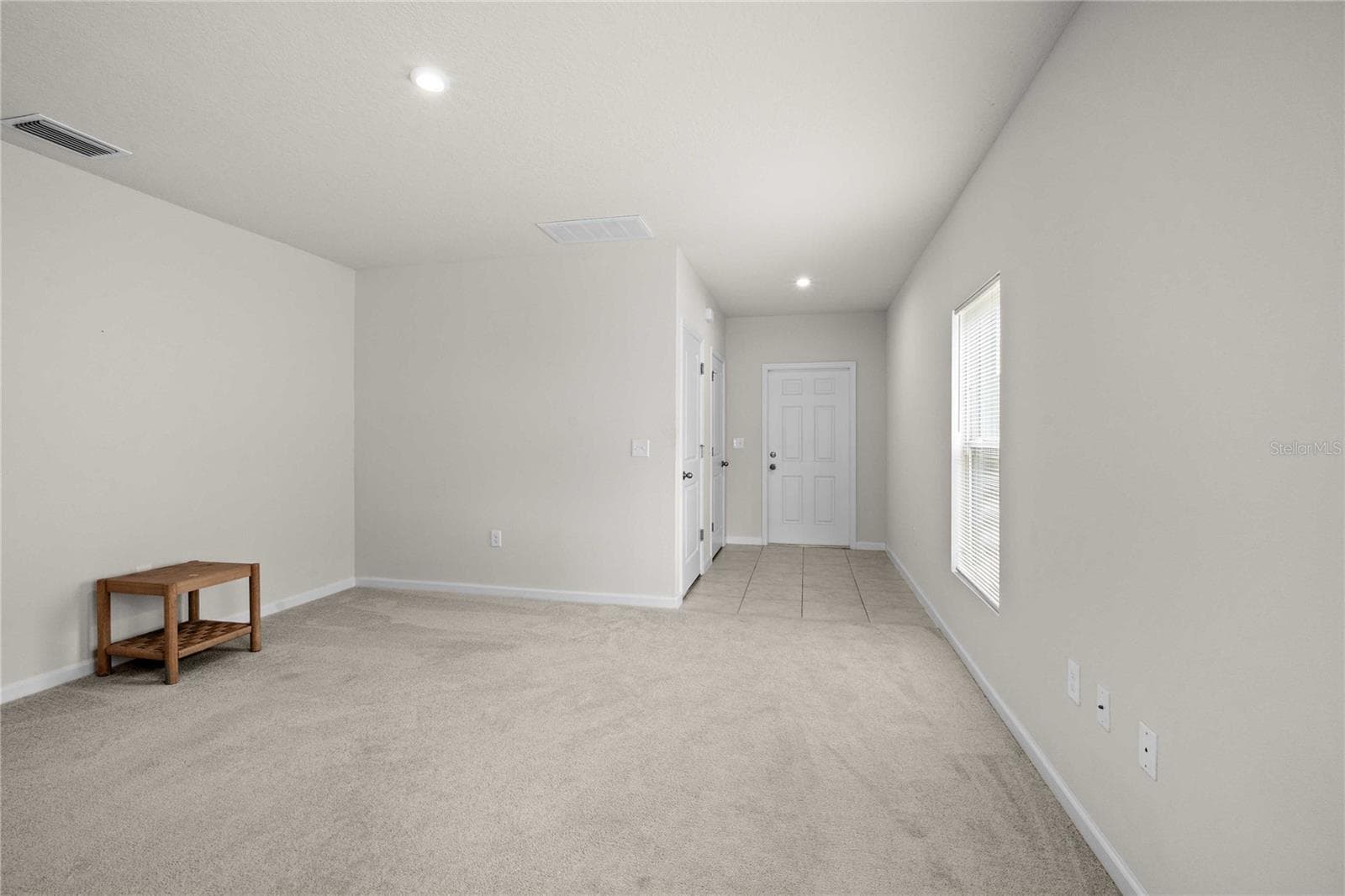 The entry foyer is tiled and has a hall closet with garage access. - 35155 JOMAR AVE, ZEPHYRHILLS