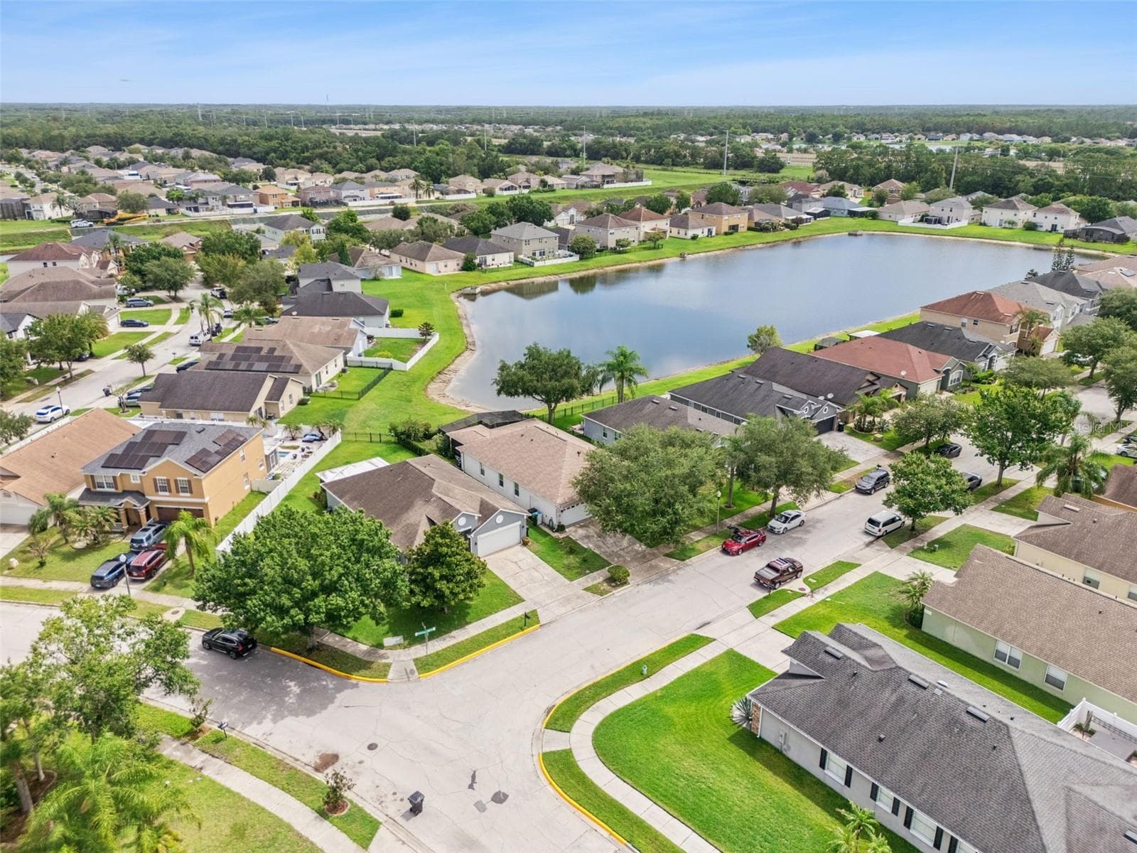 Aerial view of the home and community lake - 9955 MEDALLION BLUFF LN, ORLANDO