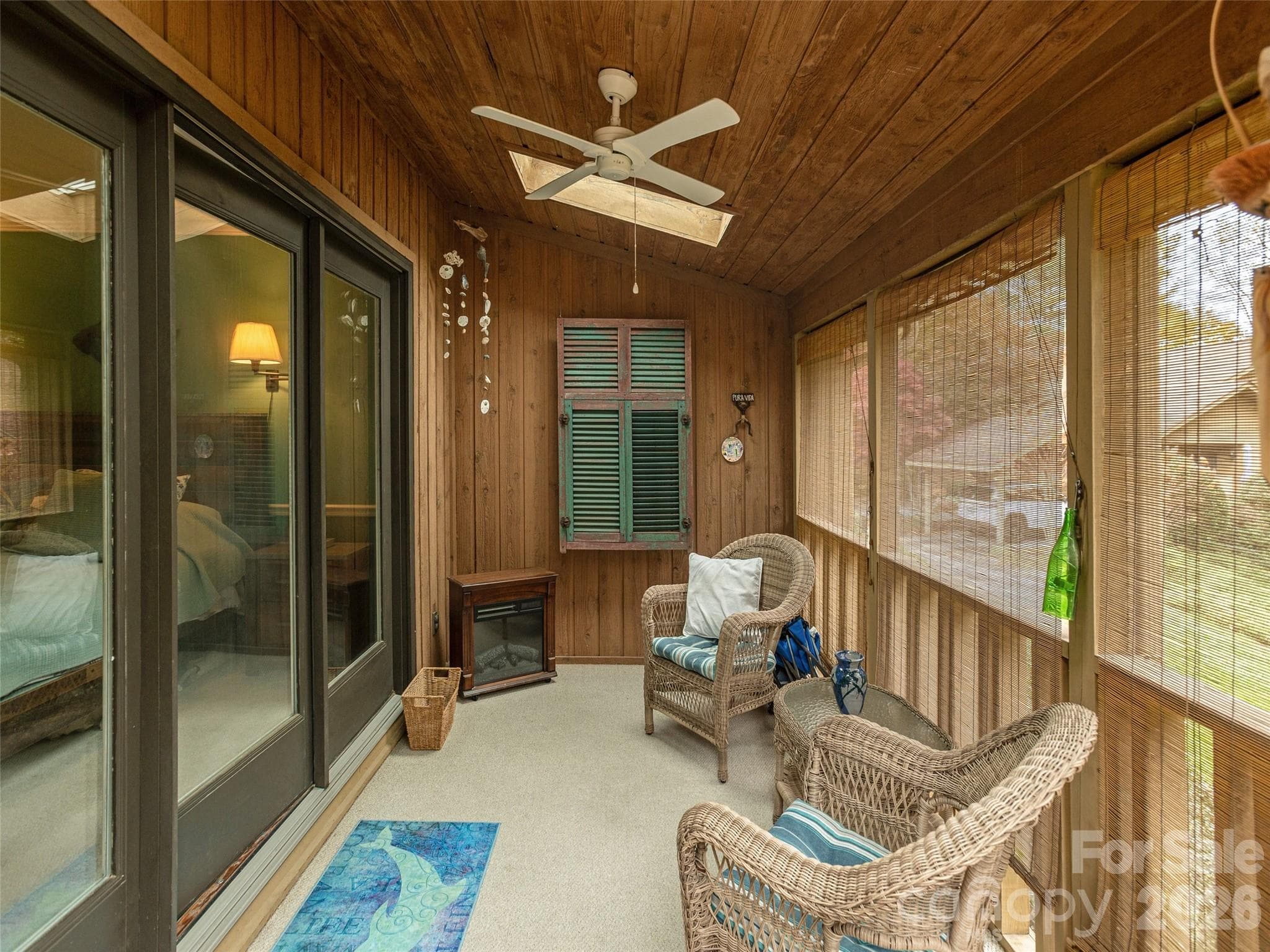 Covered screened porch off of the primary bedroom with skylight - 606 Red Oak Drive, Hendersonville