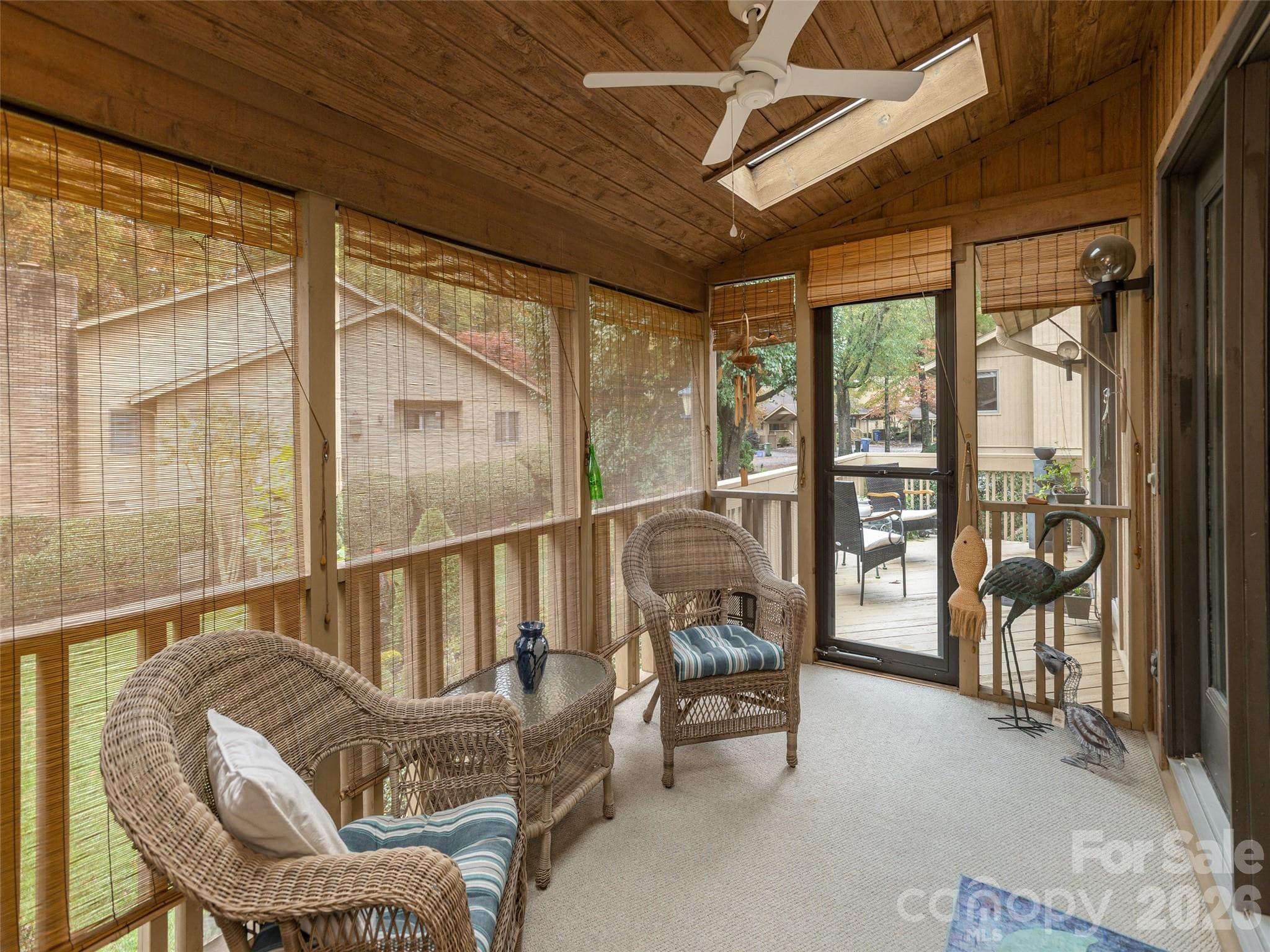 Covered screened porch entry to open back porch from primary bedroom. - 606 Red Oak Drive, Hendersonville