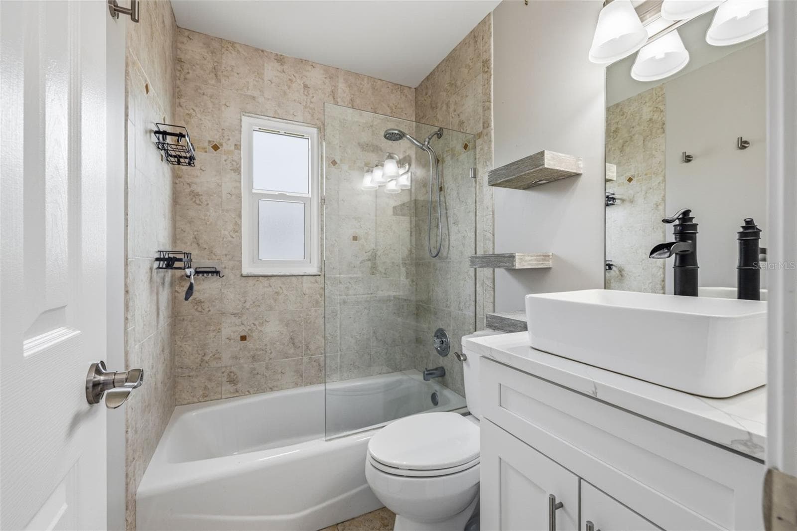 Bathroom features updated vanity and basin style sink with new fixtures. Shower/tub Combo, comfort level toilet. - 4320 FLORAMAR TER, NEW PORT RICHEY