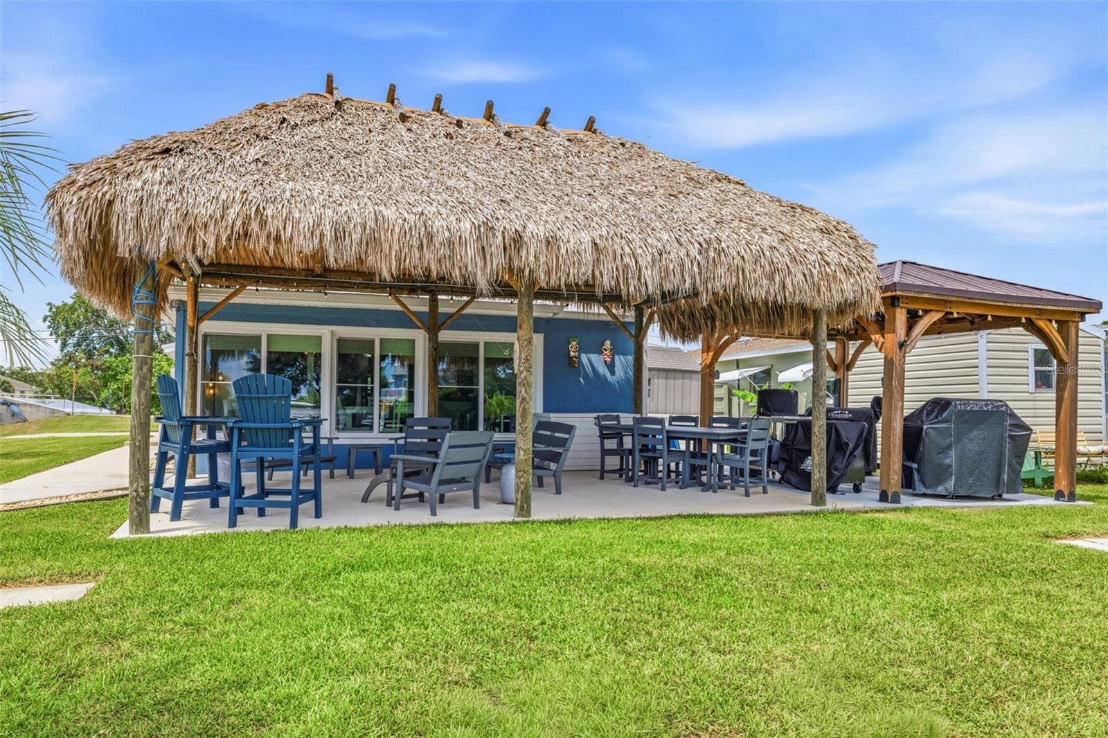Your dream backyard awaits you! A GIANT Palapa integrated with lights and speaker system. Encompasses two large seating areas! Ex large Pergola houses all the outdoor cooking options! BBQ! Smoker! Flat Grills! - 4320 FLORAMAR TER, NEW PORT RICHEY