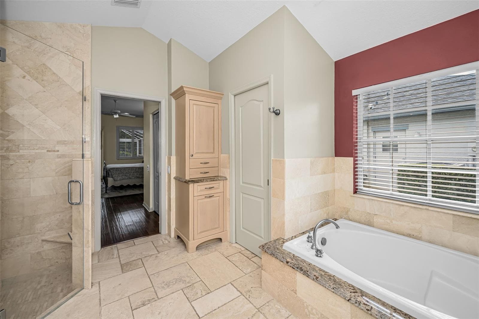Primary bathroom with pocket door to water closet - 4084 LIGUSTRUM DR, PALM HARBOR