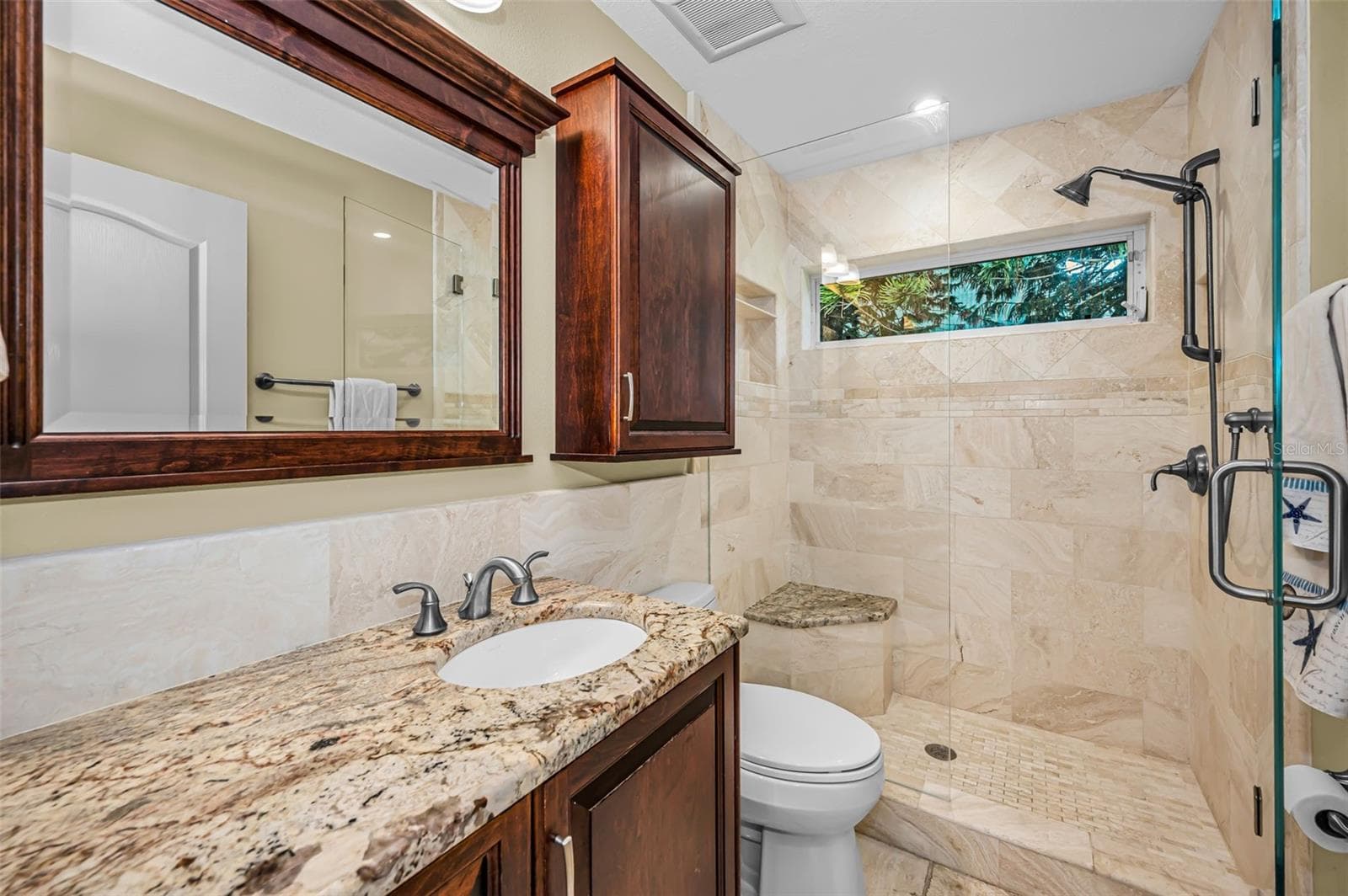 Guest Bathroom w/custom cabinetry and glass walk-in shower - 4084 LIGUSTRUM DR, PALM HARBOR