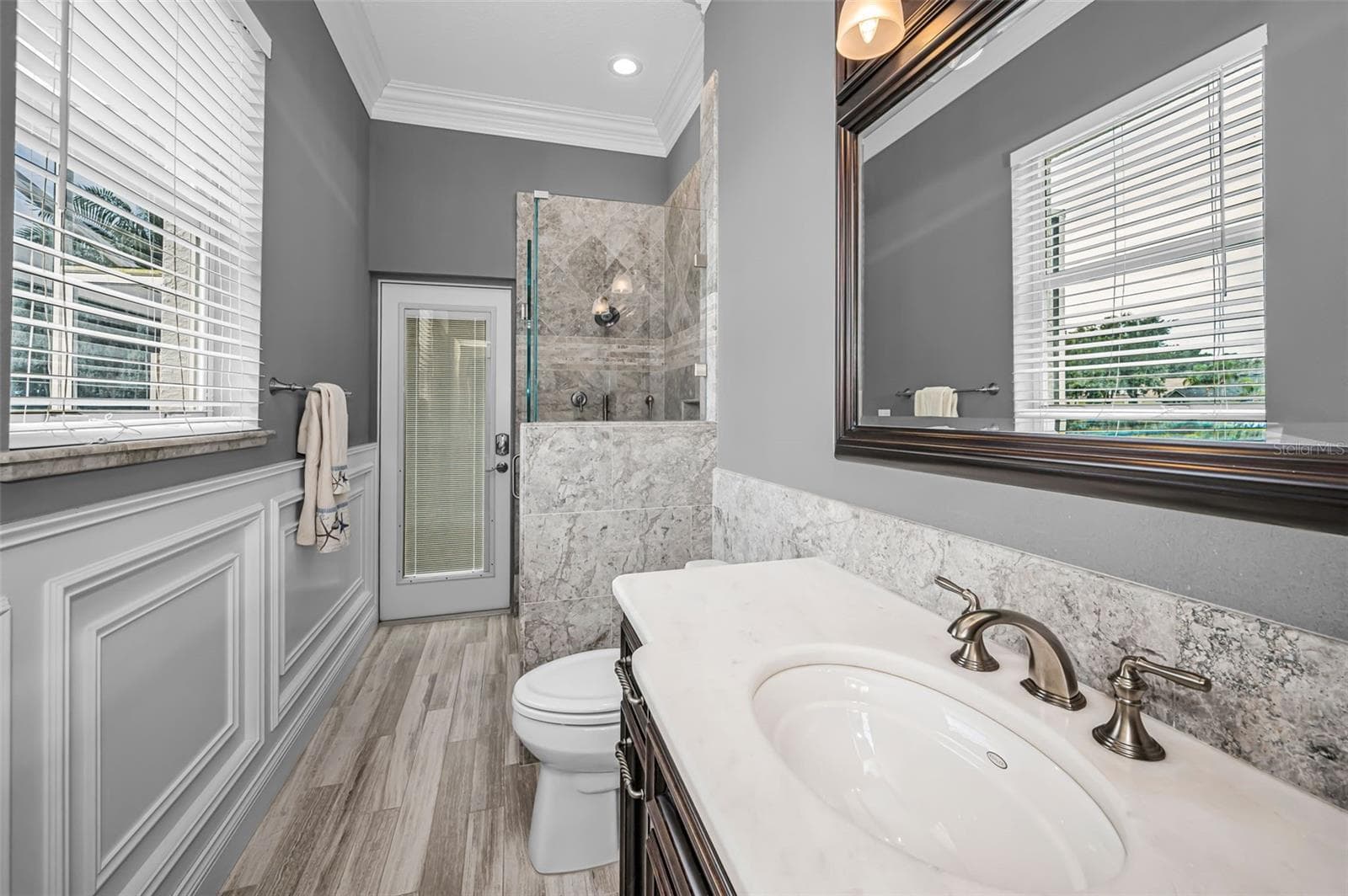 Pool bathroom w/custom cabinetry and glass walk-in shower - 4084 LIGUSTRUM DR, PALM HARBOR