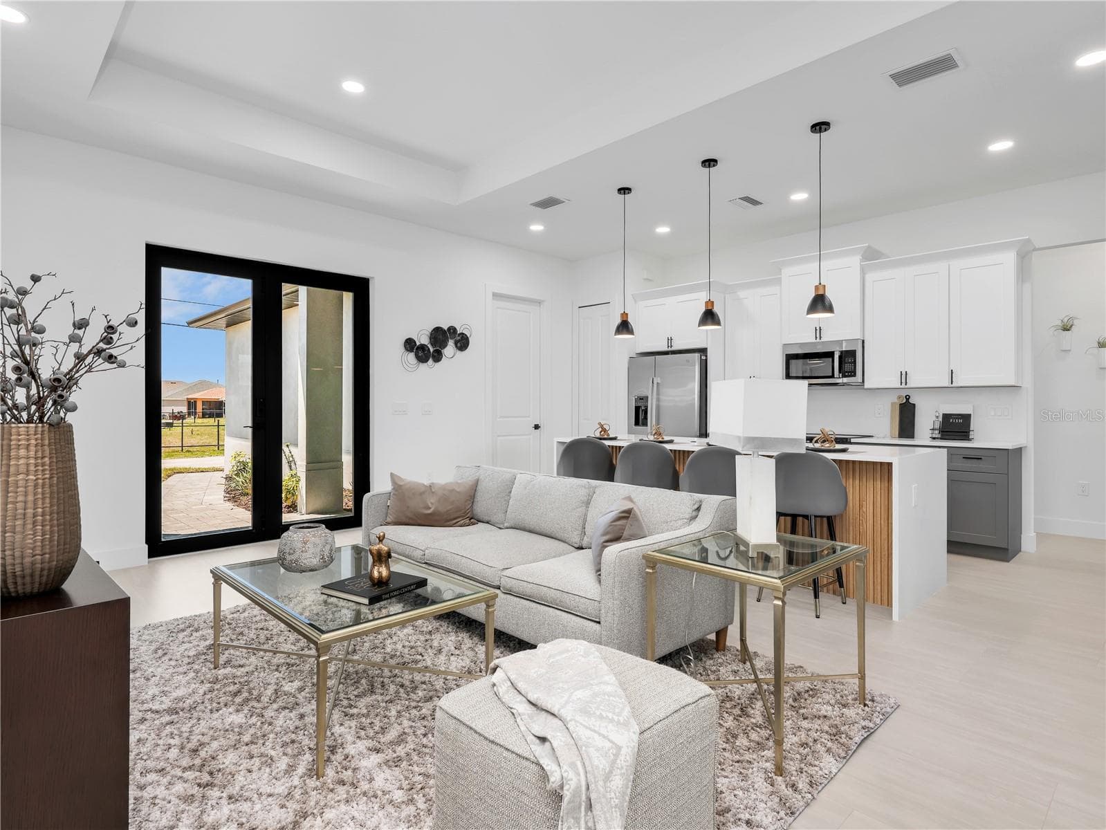 Living Room and Kitchen picture taken from anoter model home - 1015 NW 23RD AVE, CAPE CORAL