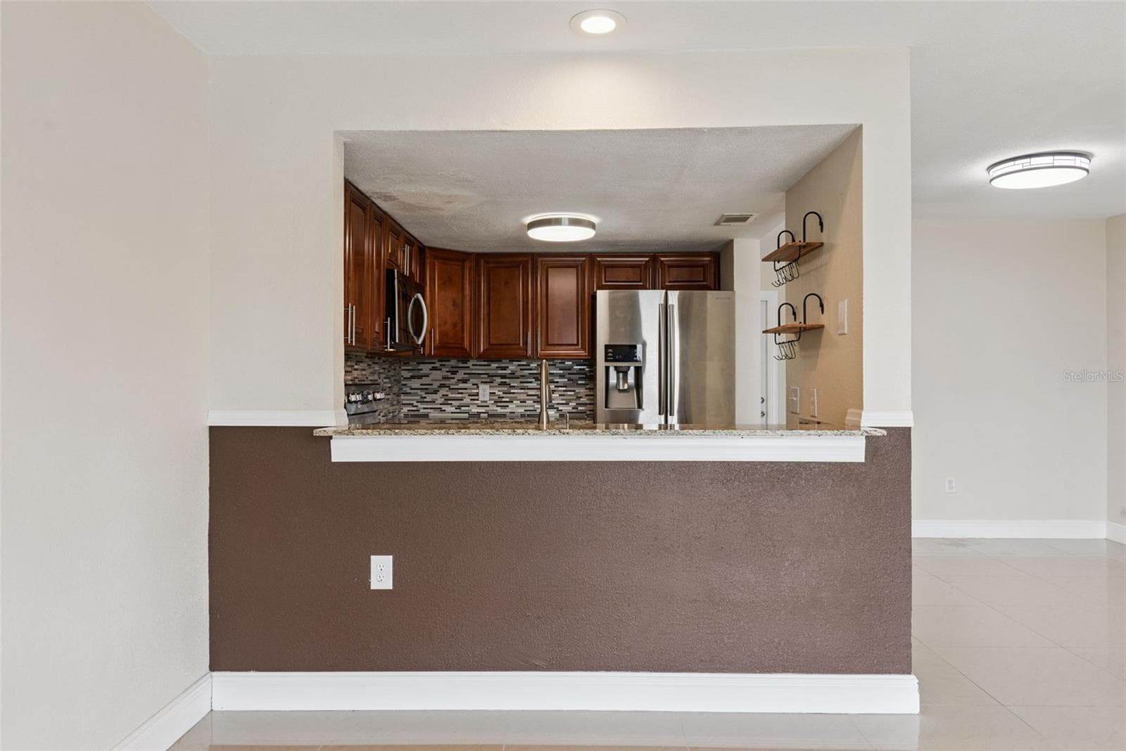View to Kitchen from Dining Room - 214 MAJORS LN #C, KISSIMMEE