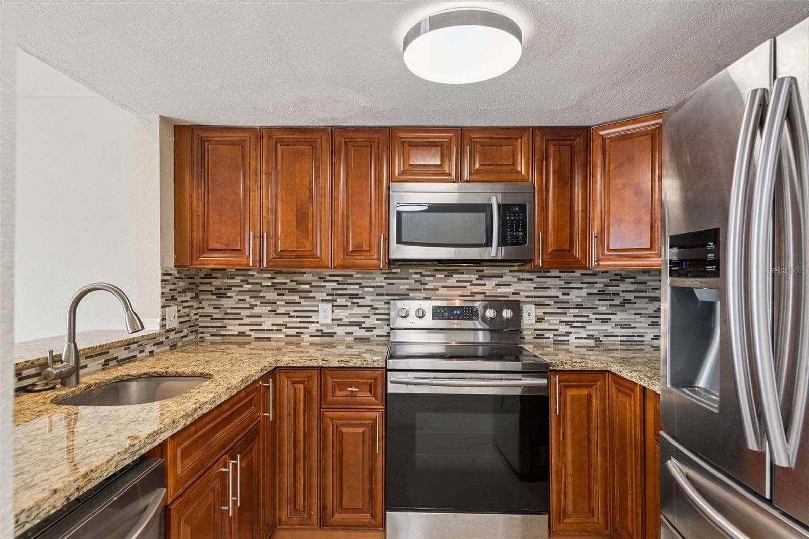 Kitchen with Granite Countertops and new Stainless Steel Appliances - 214 MAJORS LN #C, KISSIMMEE