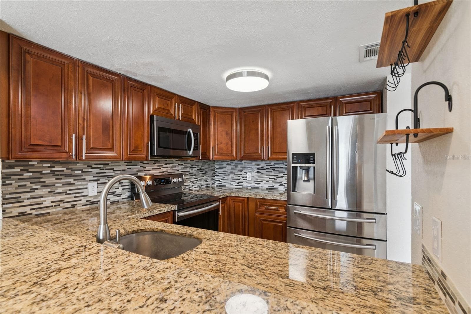 Kitchen with Granite Countertops and new Stainless Steel Appliances - 214 MAJORS LN #C, KISSIMMEE