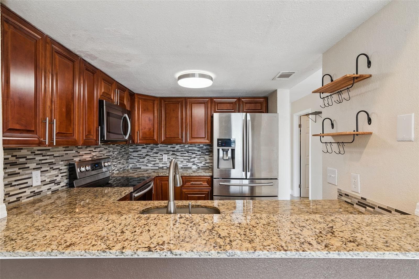 Kitchen with Granite Countertops and new Stainless Steel Appliances - 214 MAJORS LN #C, KISSIMMEE