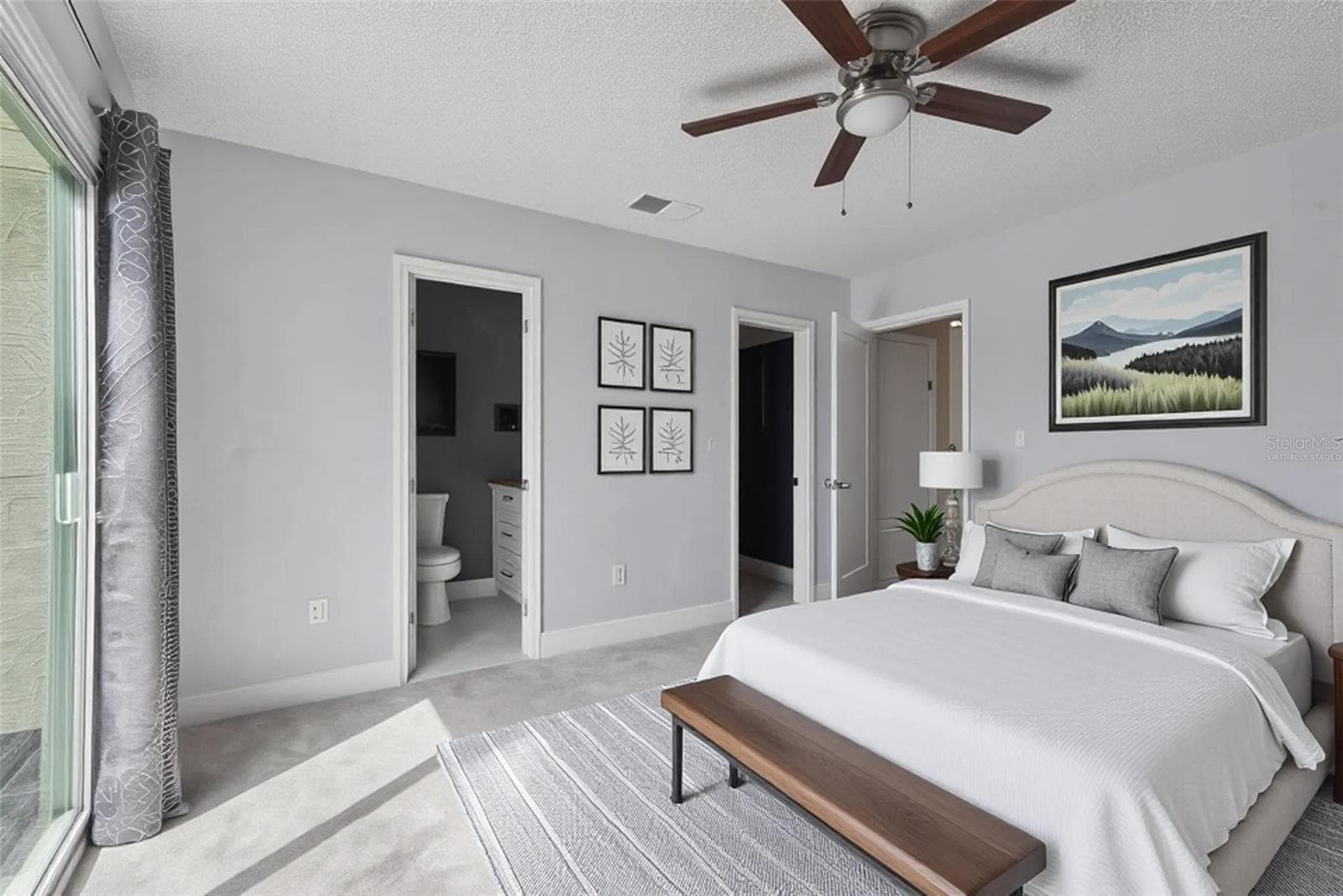 Primary Bedroom with view to primary -bathroom and walk-in Closet - Virtually Staged - 214 MAJORS LN #C, KISSIMMEE