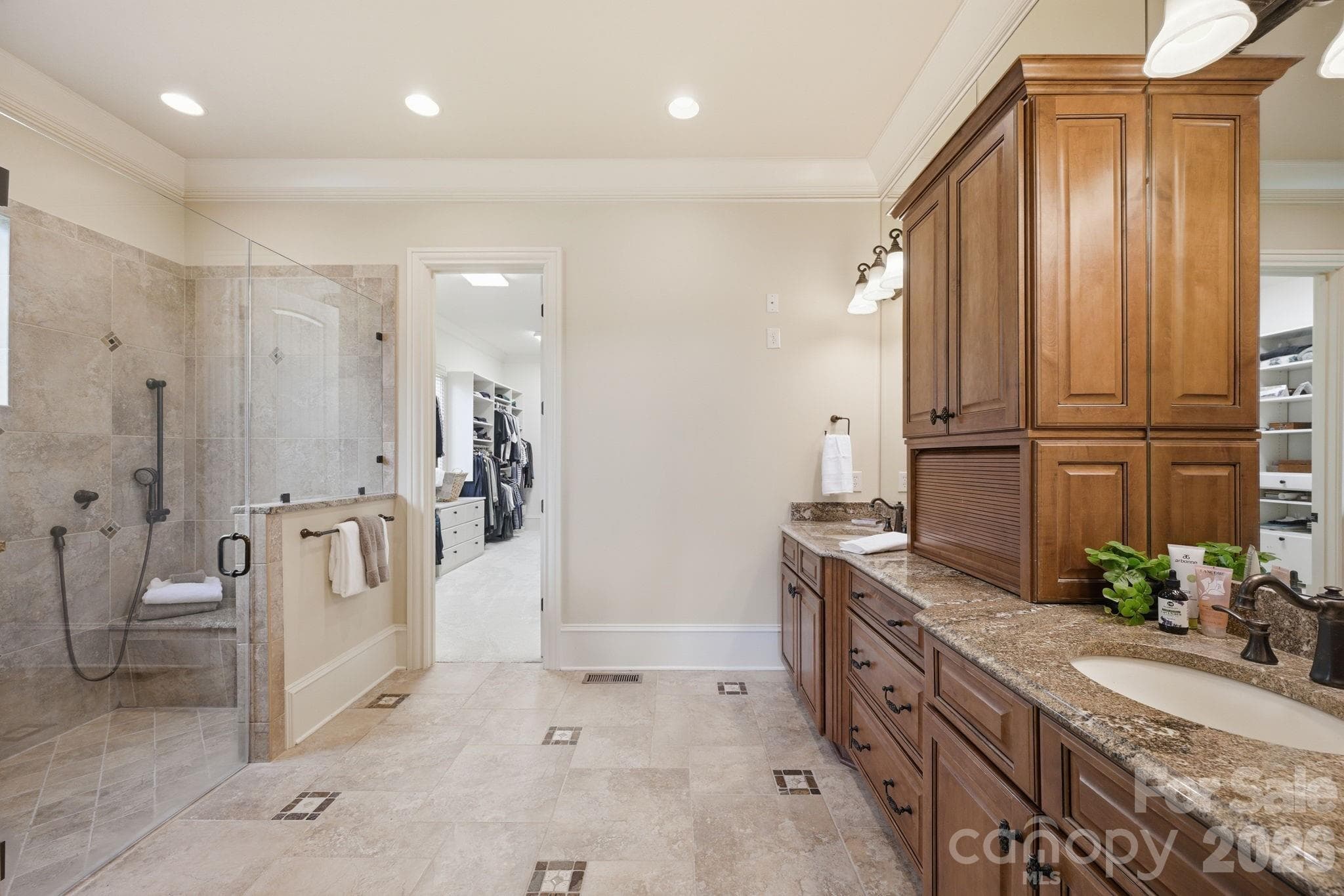 Heated bathroom floors, custom cabinets, frameless glass and tile 9'7"x3'8" shower w/bench & stained glass accent window - 8528 Waxhaw Creek Road, Waxhaw