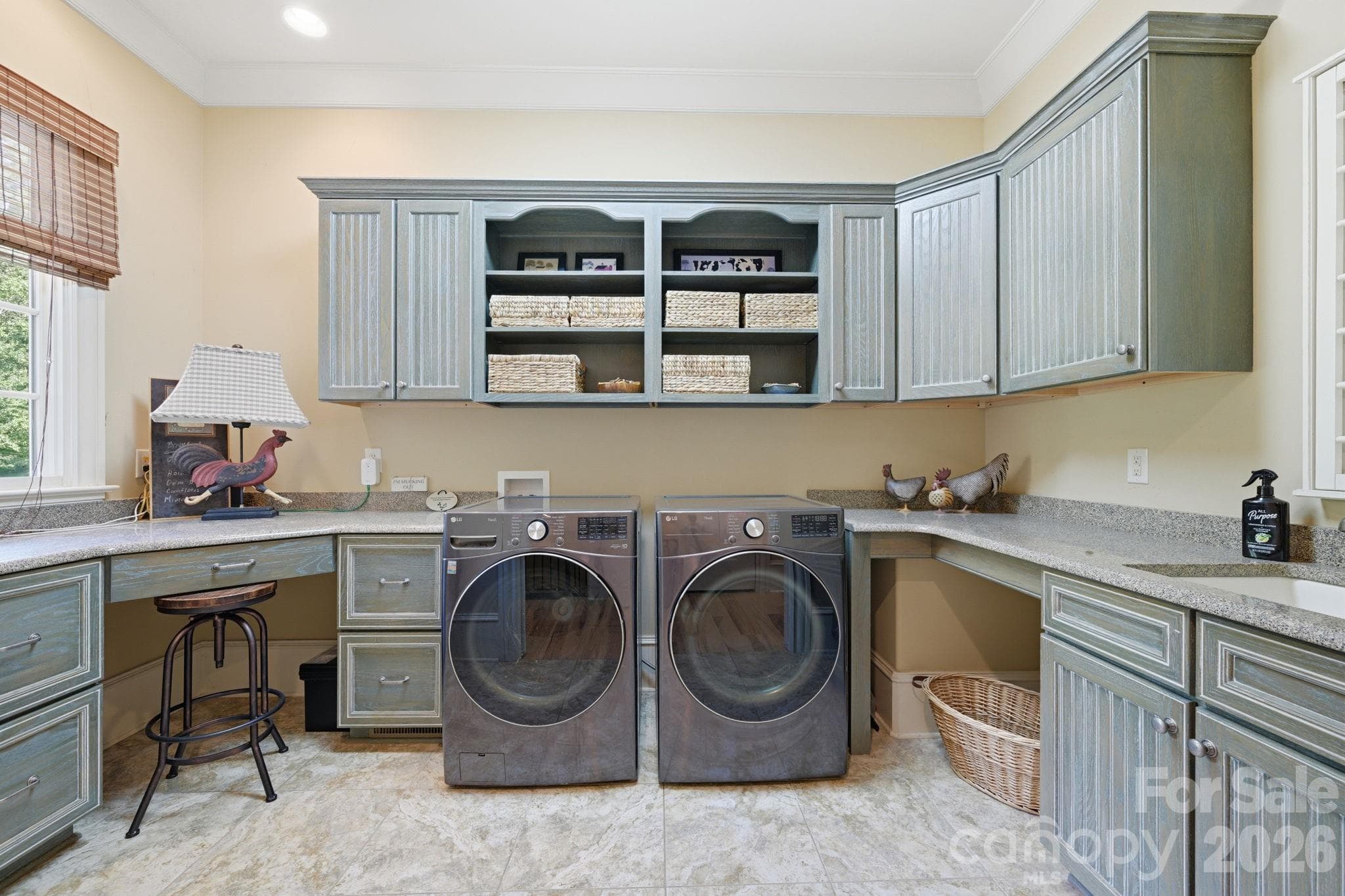 Main floor laundry room and office with built-in desk, file cabinets and sink - 8528 Waxhaw Creek Road, Waxhaw